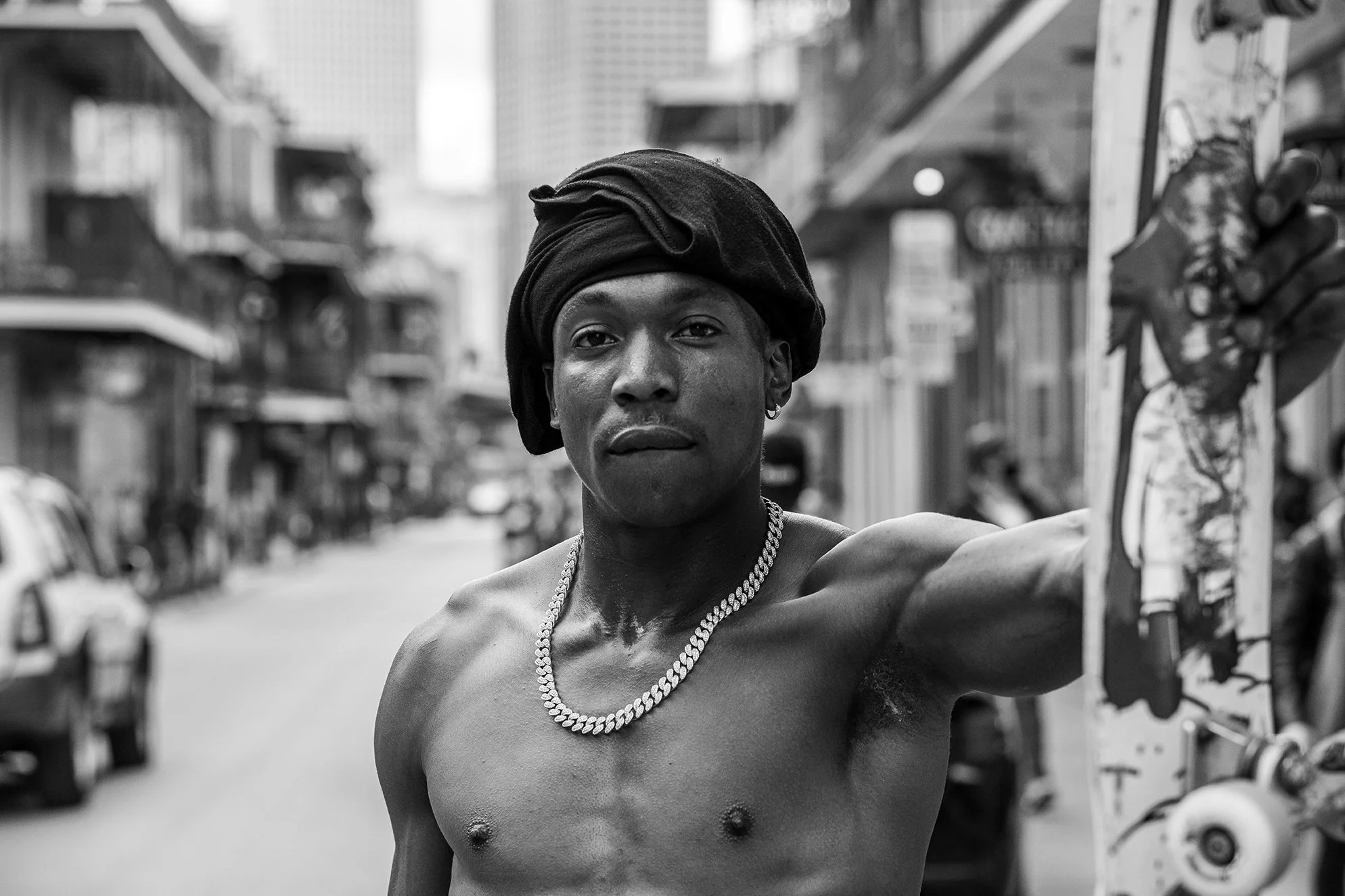 LeAndre holding his board in the street B&W portrait.jpg