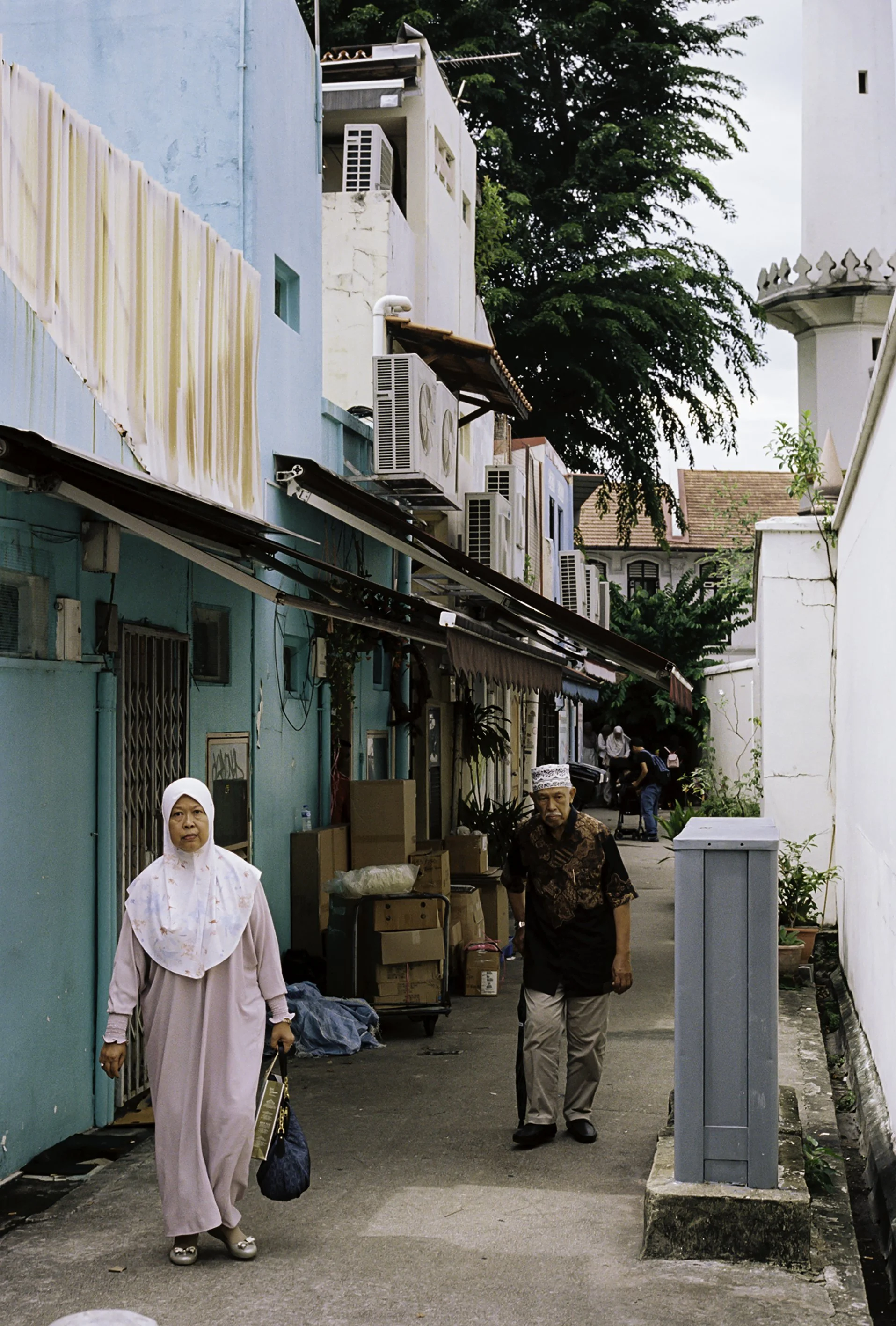 Couple walking through alley of Haji Lane.JPG