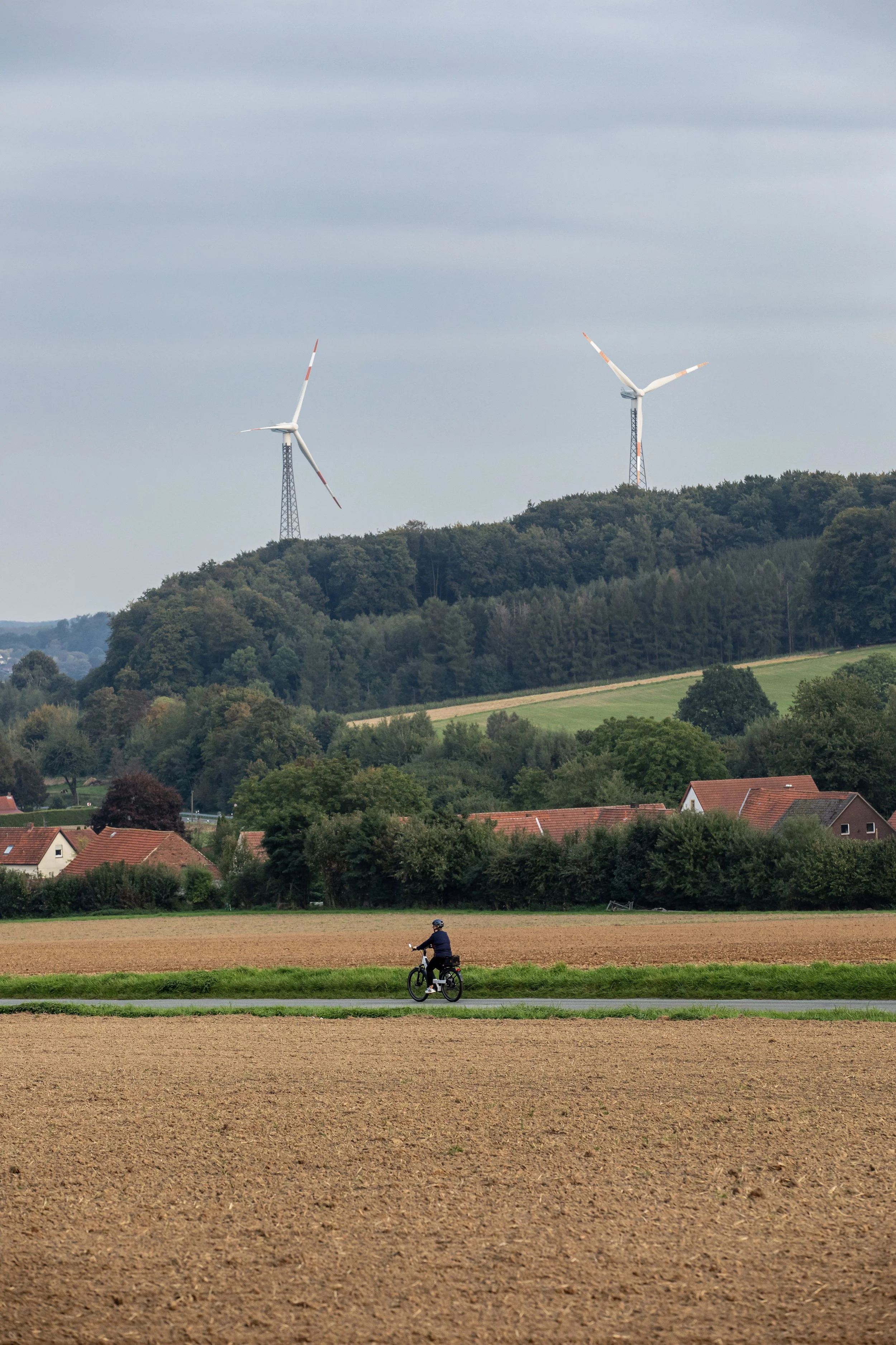 Guy riding bike on country road.JPG