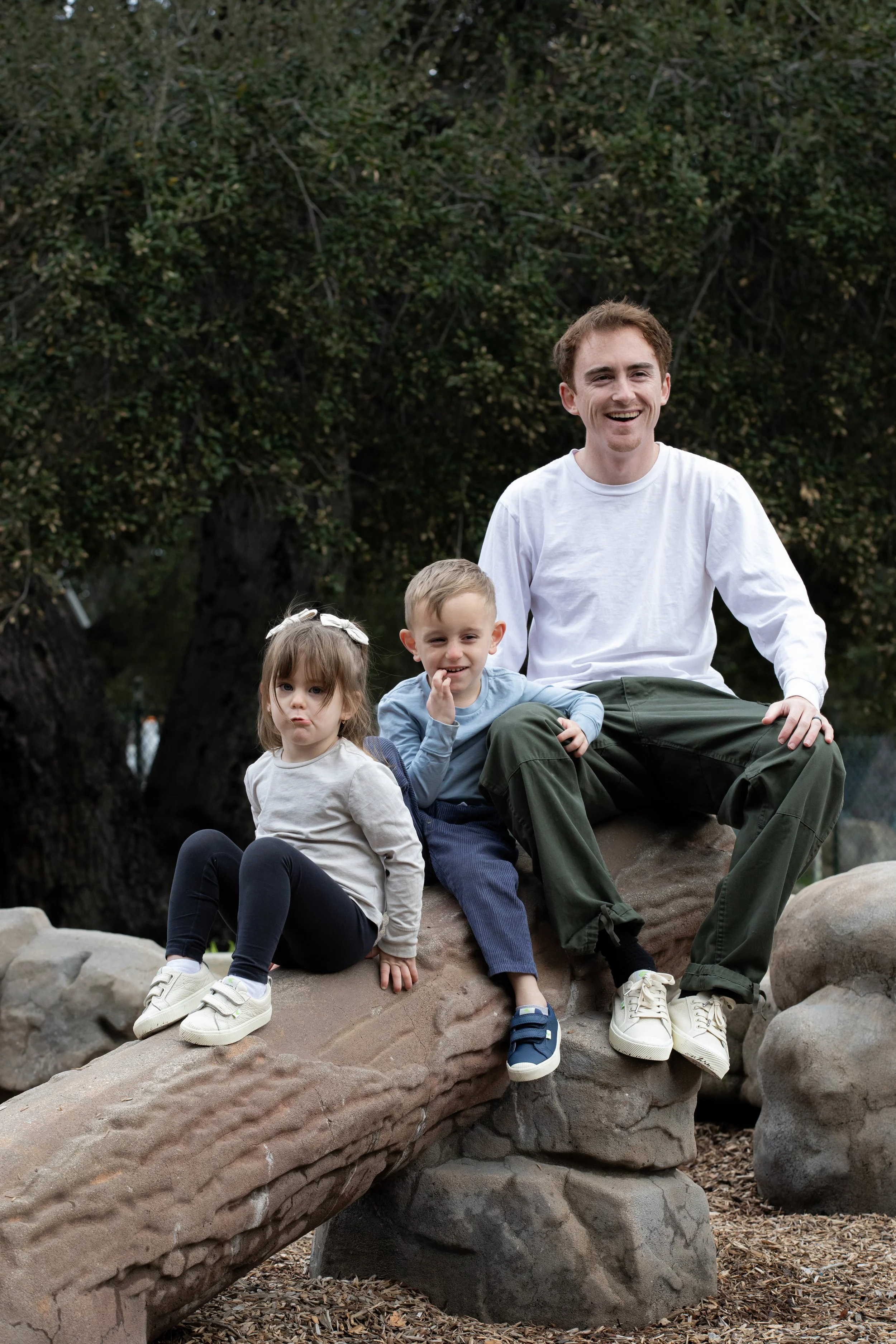 Tyler, Azai & Emy sitting on log at playground 1.JPG