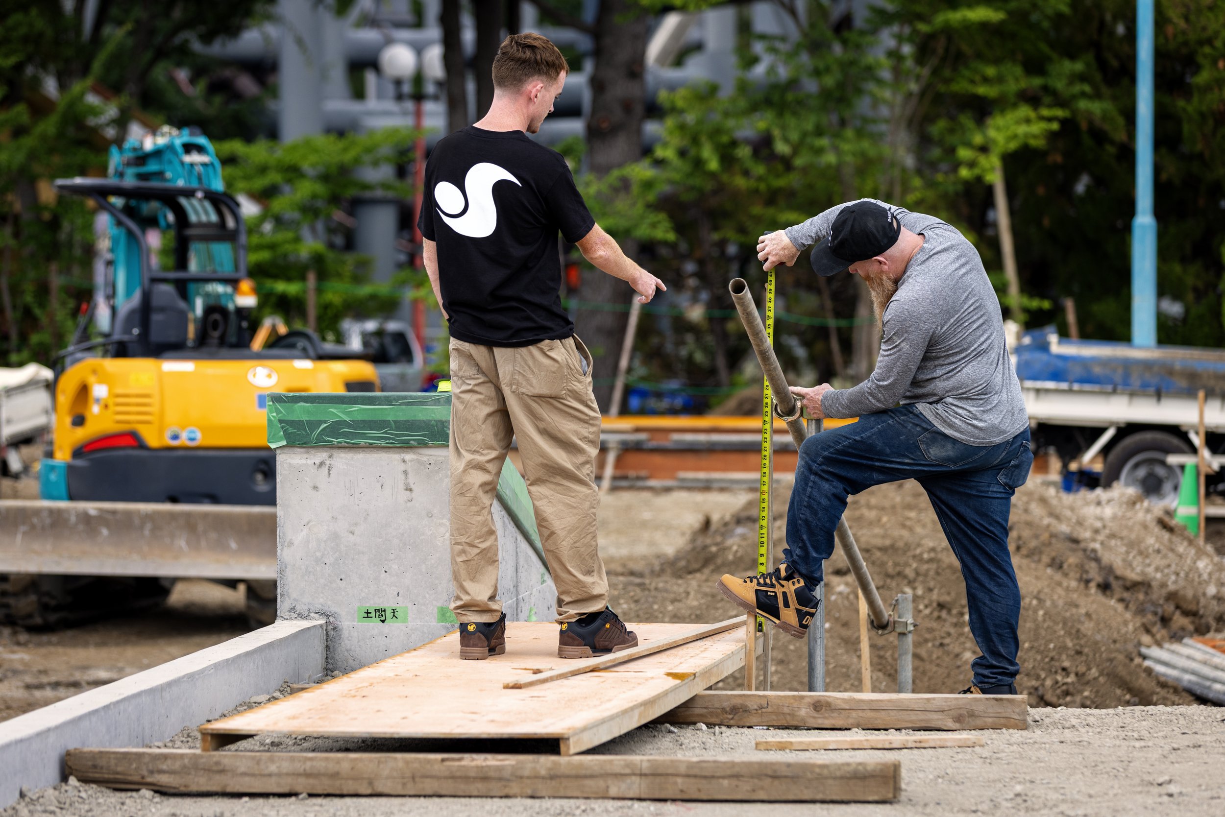 Brent & Tyler measuring rail at park.JPG