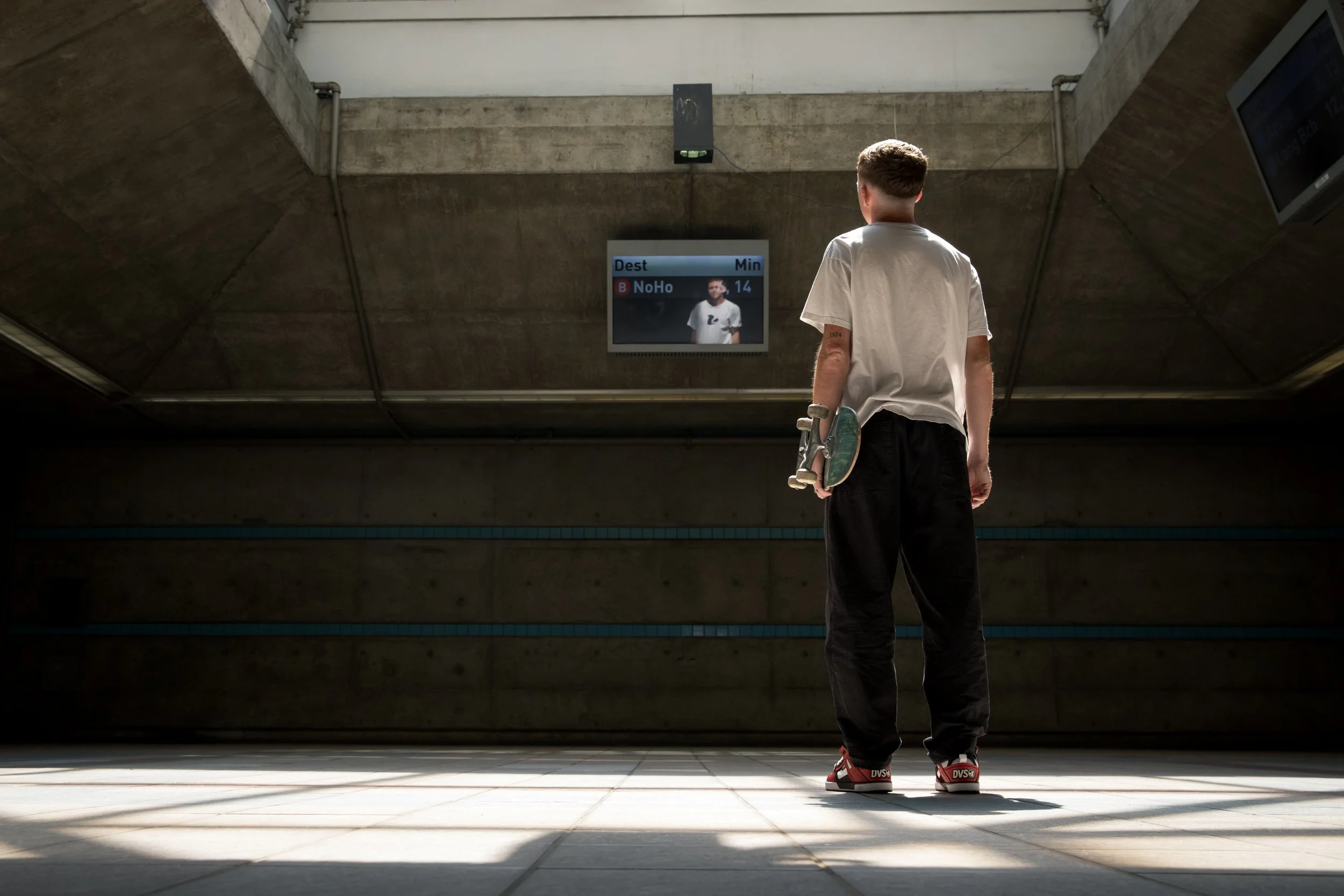 Tyler looking at train station screen portrait.JPG