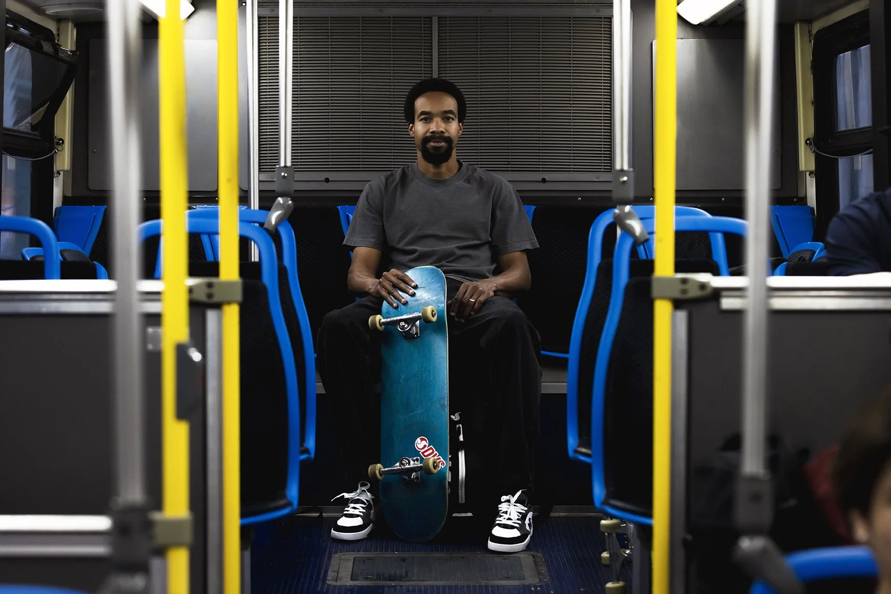 CANON_20260417_TIMMY WEARING BLK-GREY-WHT SLOT PORTRAIT ON BUS.jpg