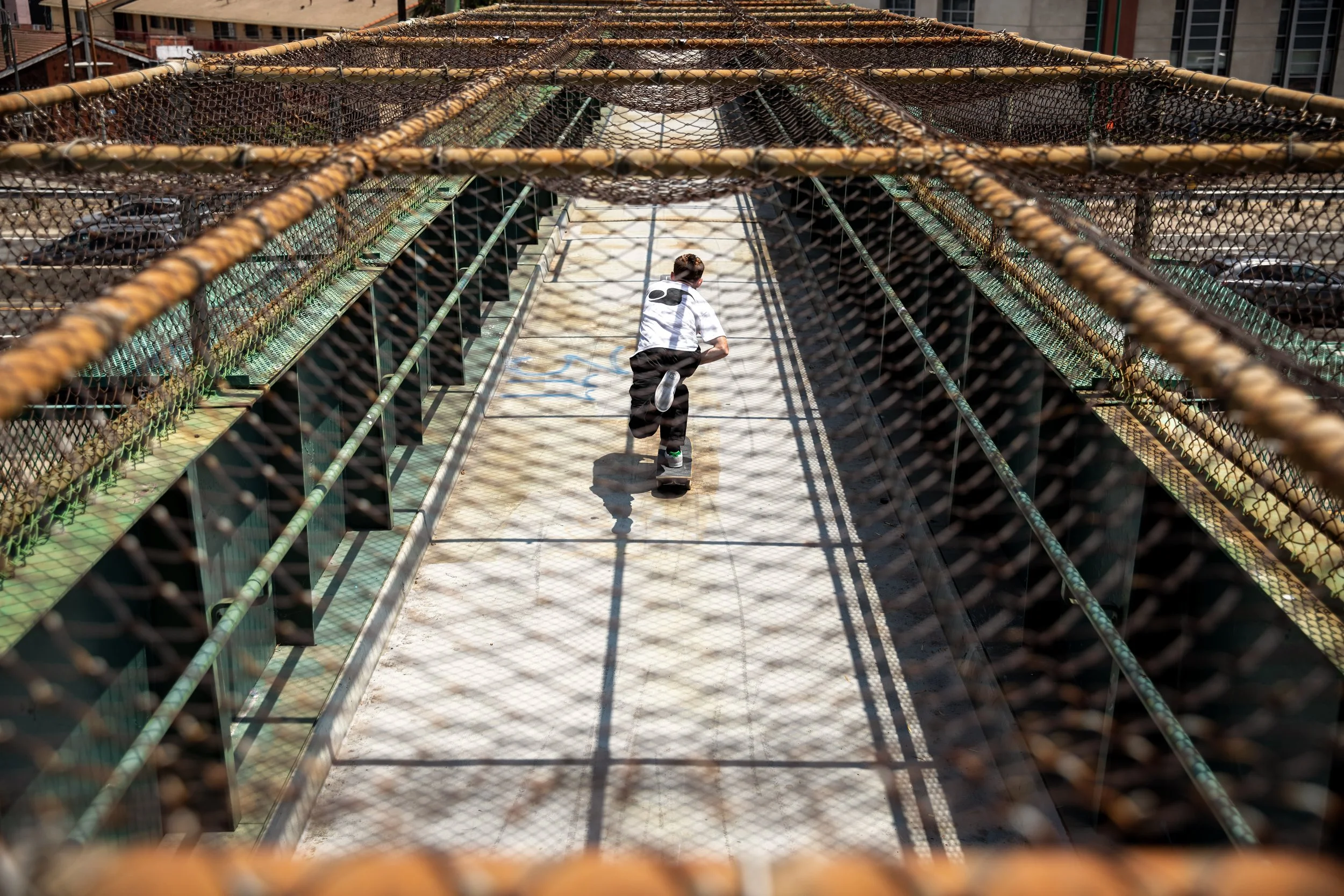 Tyler pushing across bridge 2.JPG