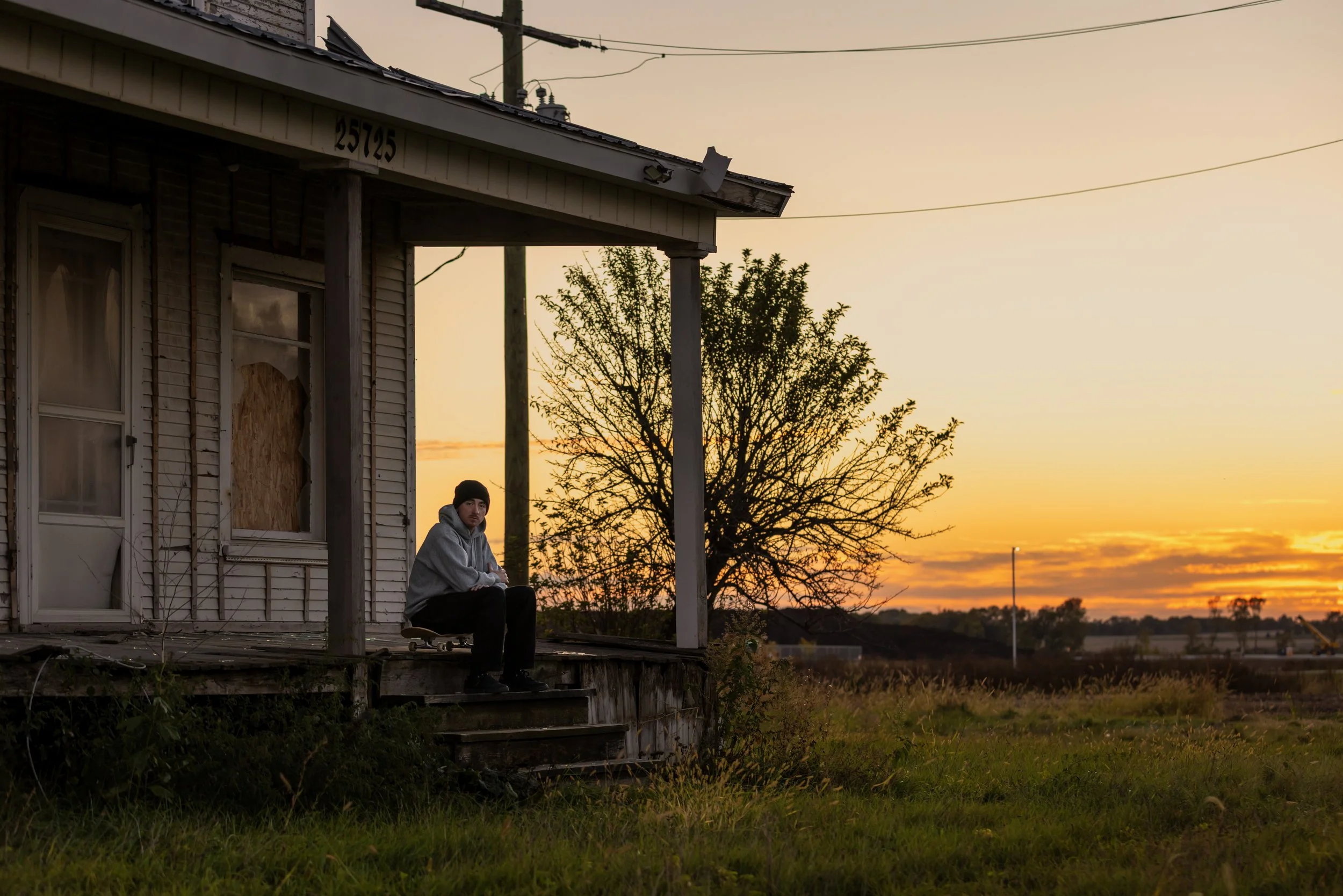Tyler portrait on porch of abandoned house 1.JPG