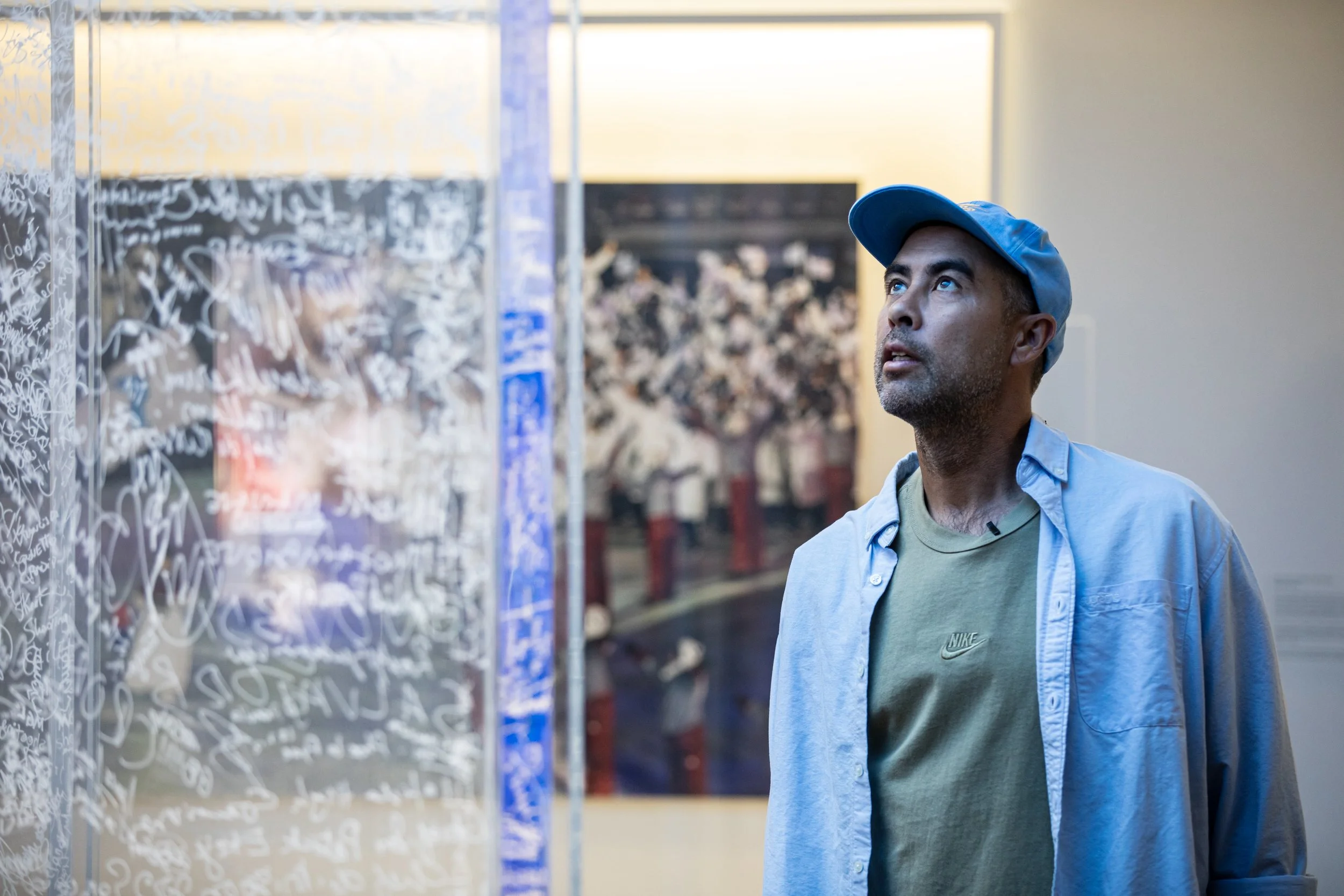 Koston looking at wall of signatures 1.JPG