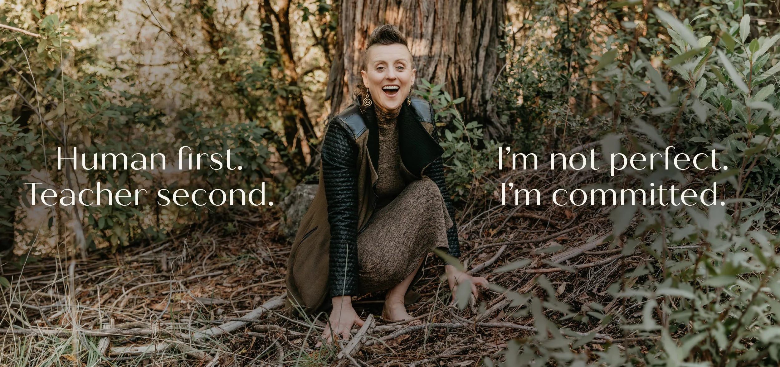 A woman sitting outdoors among trees and foliage, smiling with an open mouth, wearing a leather jacket and a long skirt, with a quote overlay saying 'Human first. Teacher second. I'm not perfect. I'm committed.'
