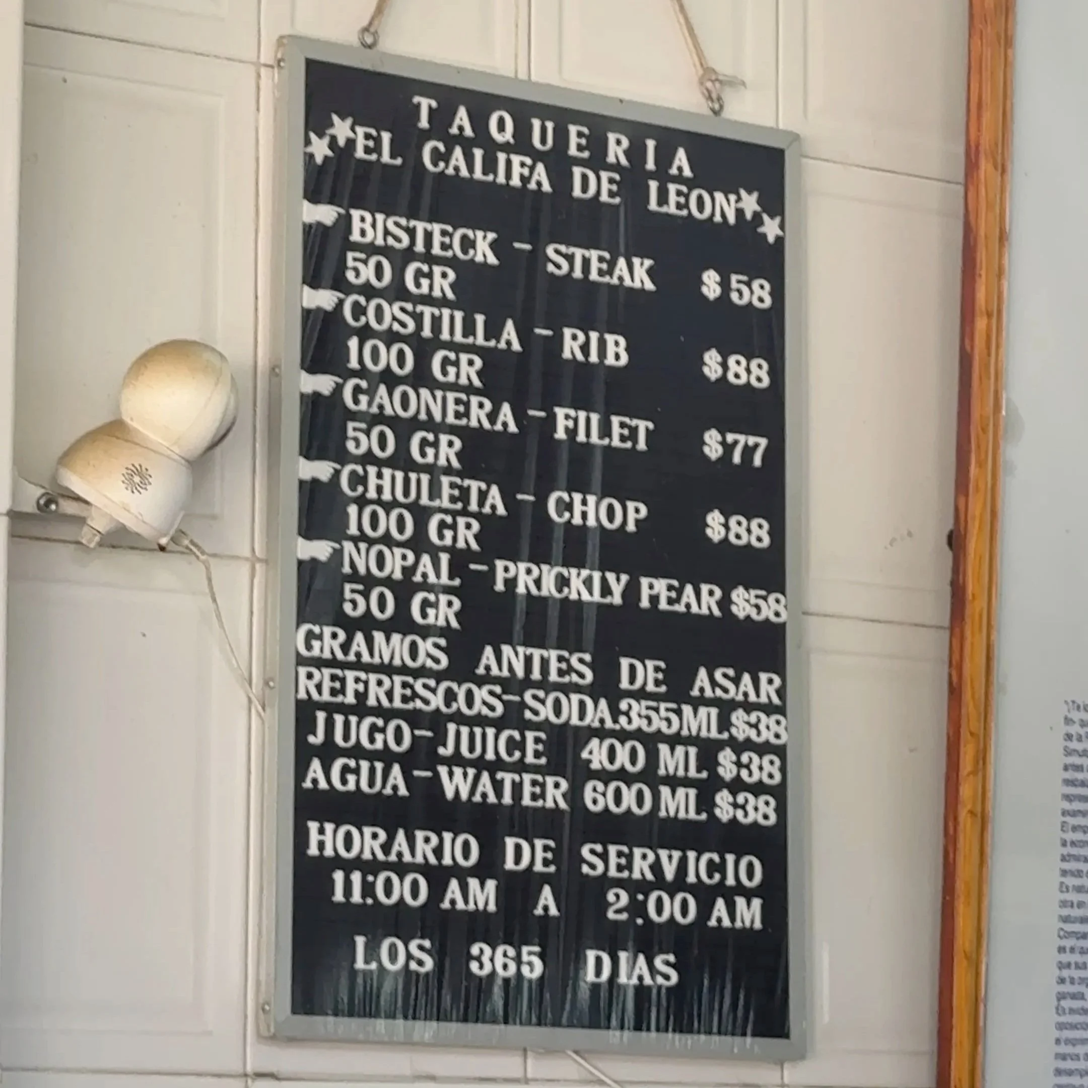 Menu board at El Califa de León, the Michelin star taqueria in Mexico City