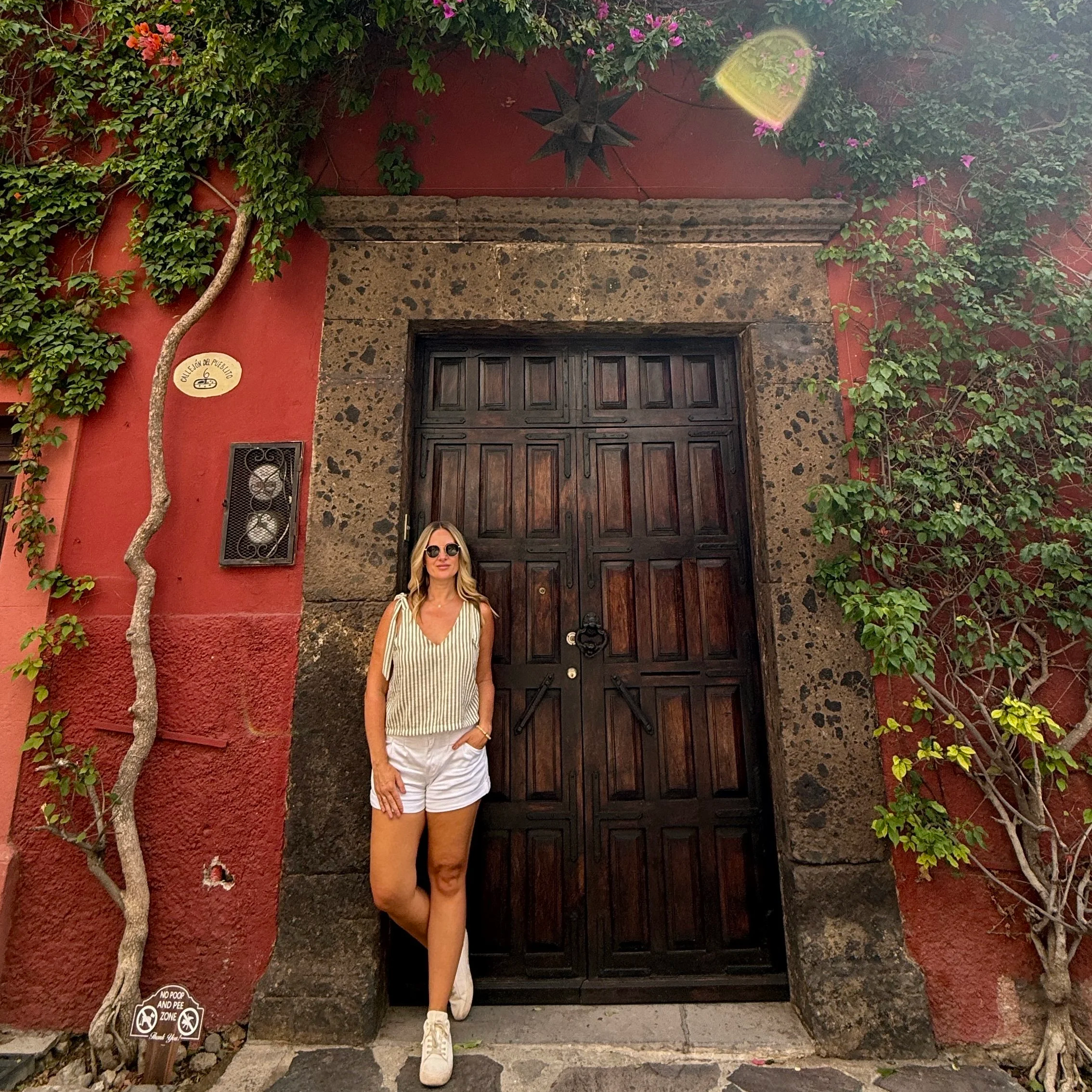 Megan standing in front of a doorway in San Miguel de Allende in Mexico