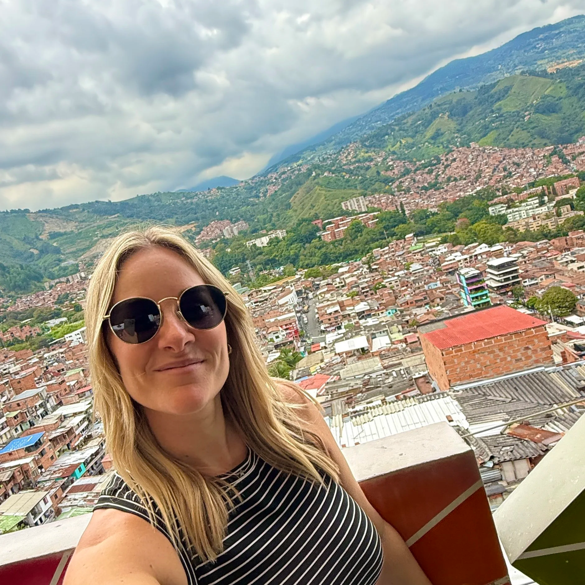 Megan in Medellin, Colombia with a view of Comuna 13 and the mountains in the background