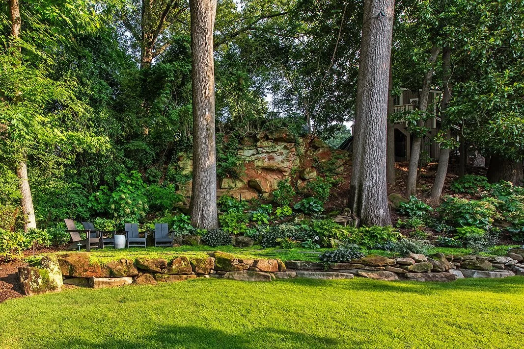 A perfect spot to gather this weekend!

A low boulder wall creates a flat seating terrace with mazus creeping between pavers. Lush, shade-loving plants give this backyard a mountainous feel right in the heart of the City. Some of the plants used incl
