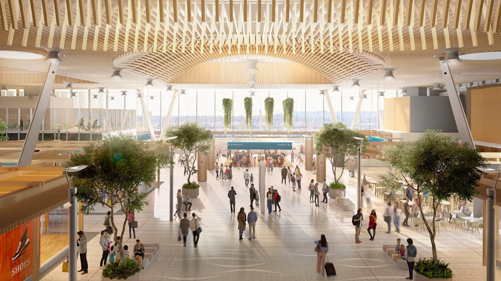 Interior of a modern train station or airport with high ceilings, hanging plants, and large windows, crowded with people walking and sitting.