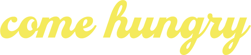 Text saying "come hungry" in yellow cursive font.
