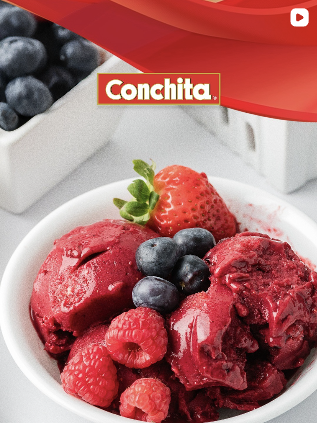 Conchita Instagram post: bowl of berry sorbet topped with fresh strawberries, blueberries and raspberries