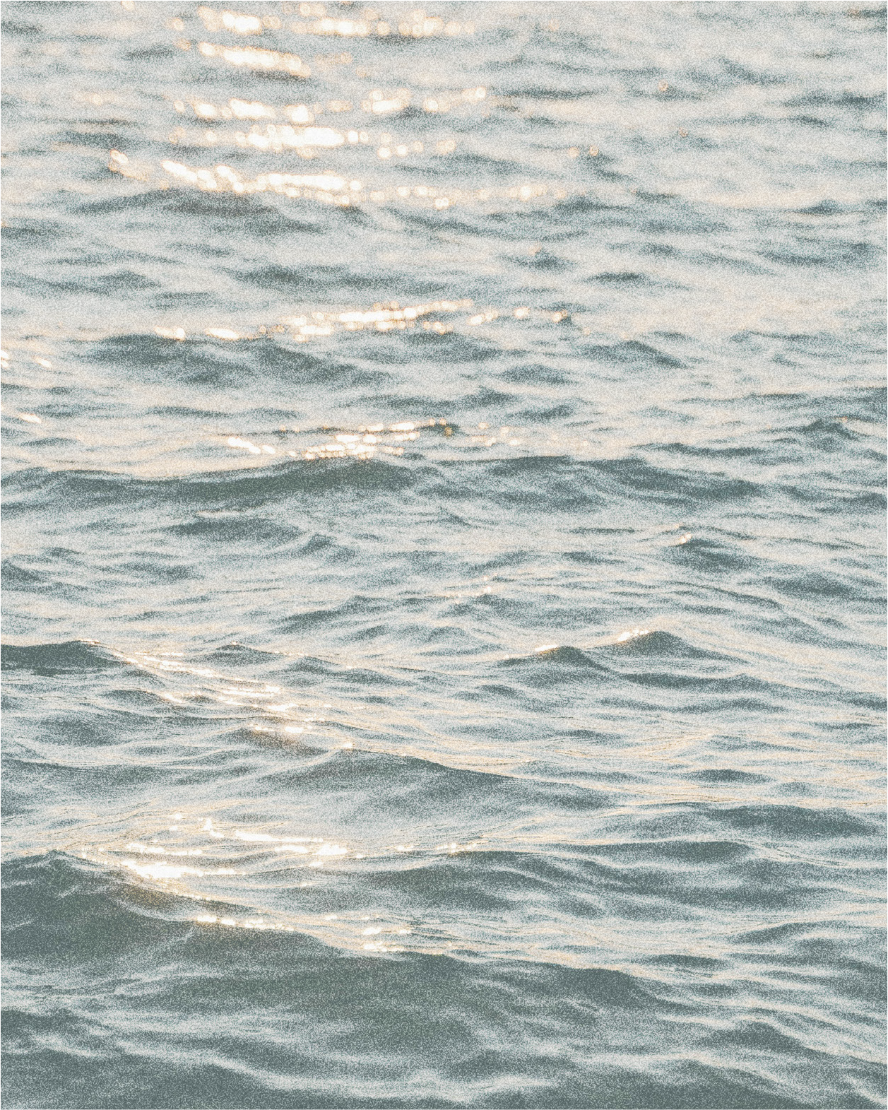 Sunlight reflecting off a body of water with gentle waves.