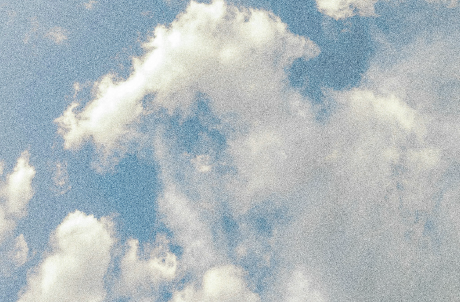 Partly cloudy sky with white clouds.