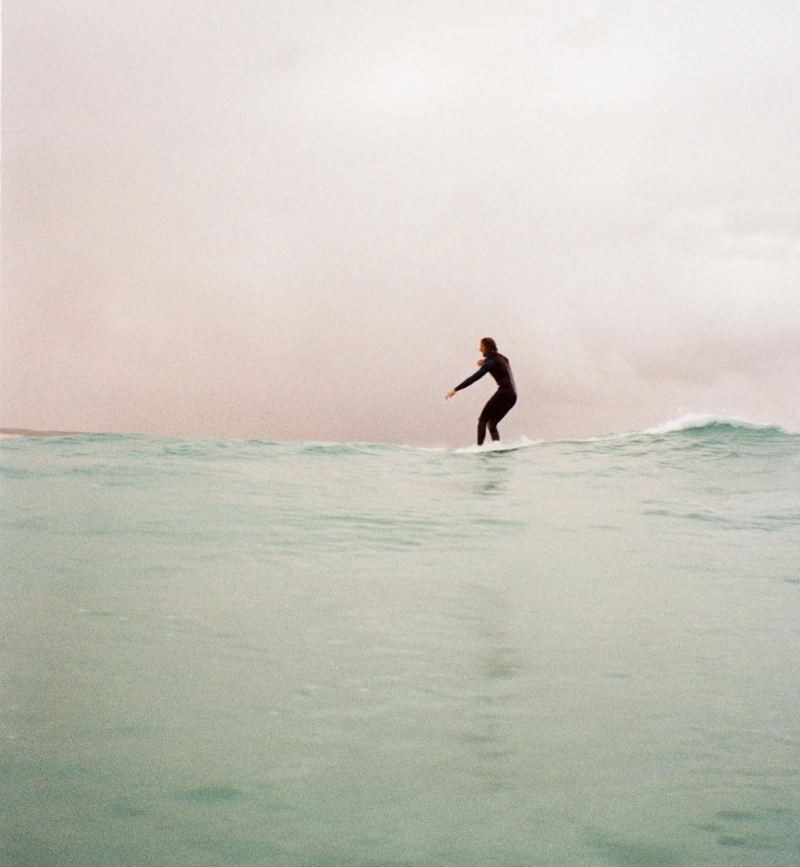 Woman surfing in ocean with waves
