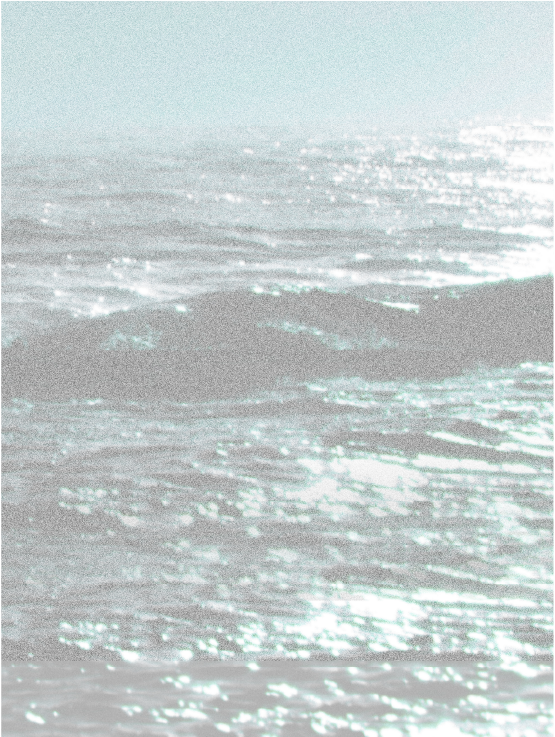 Sunlit ocean waves, shimmering under bright sunlight.