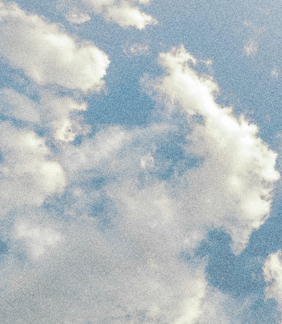 A cloudy sky with white clouds and a blue background.