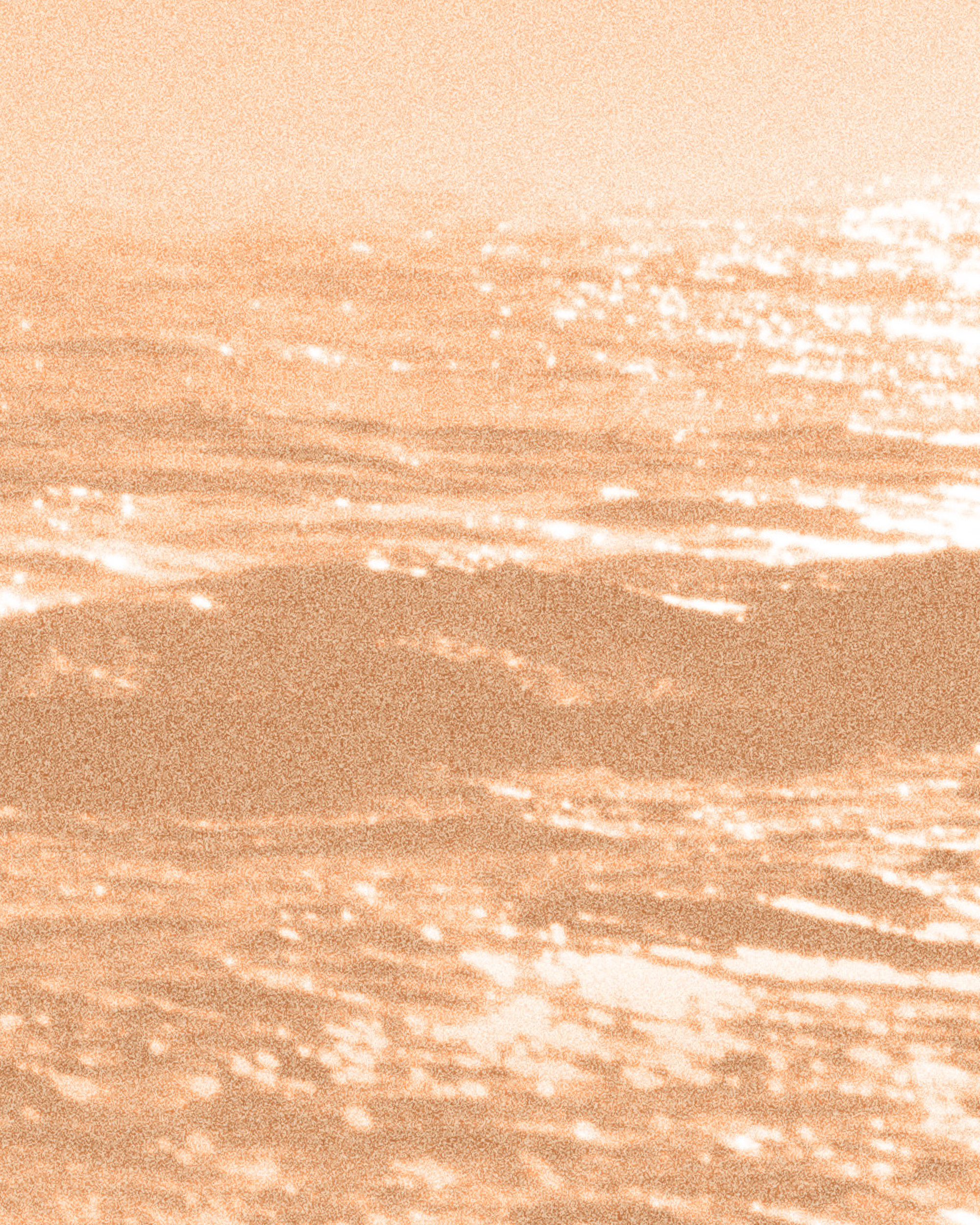 Sunset over the ocean with orange and pink hues, reflecting on the water.