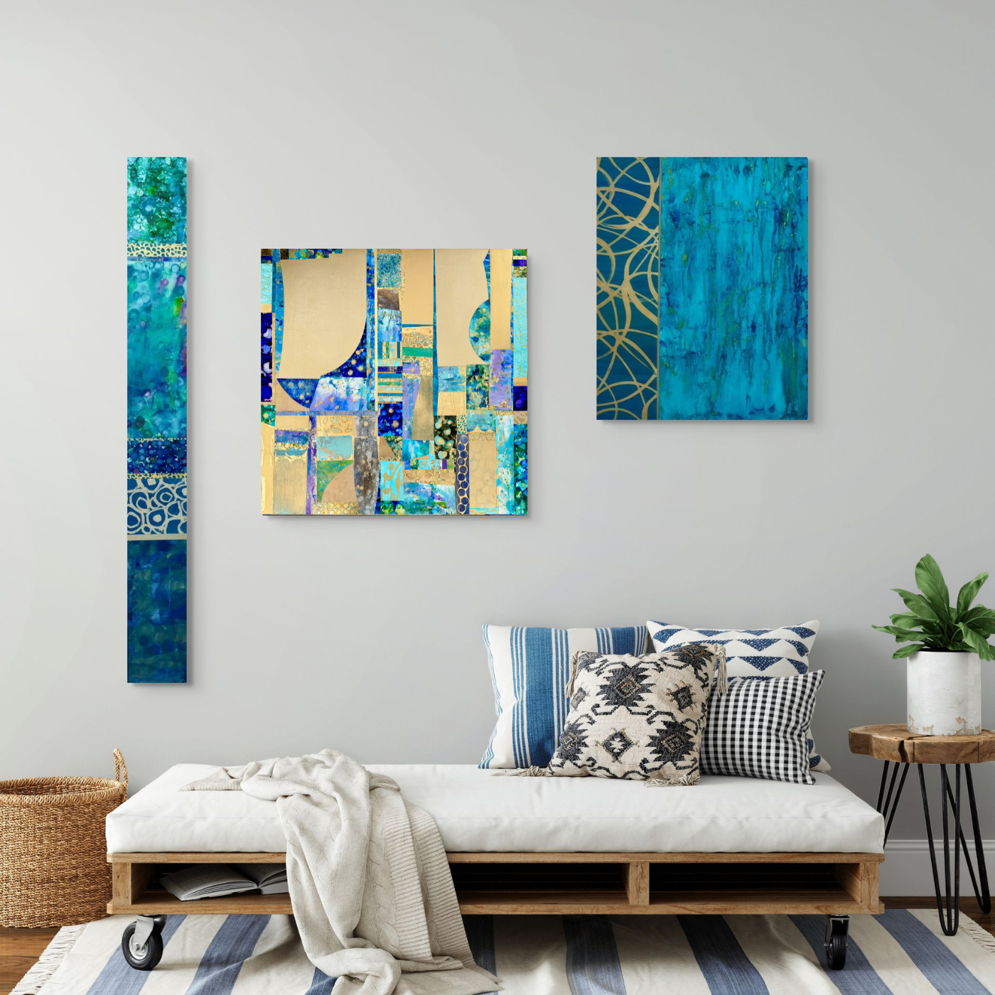 Interior living room with modern abstract blue wall art and pillows on a white daybed with a striped rug and a side table with a potted plant.