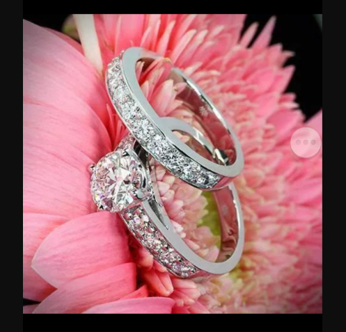 Set of 14 kt white gold engagement diamond ring & wedding diamond band placed on the pink flower