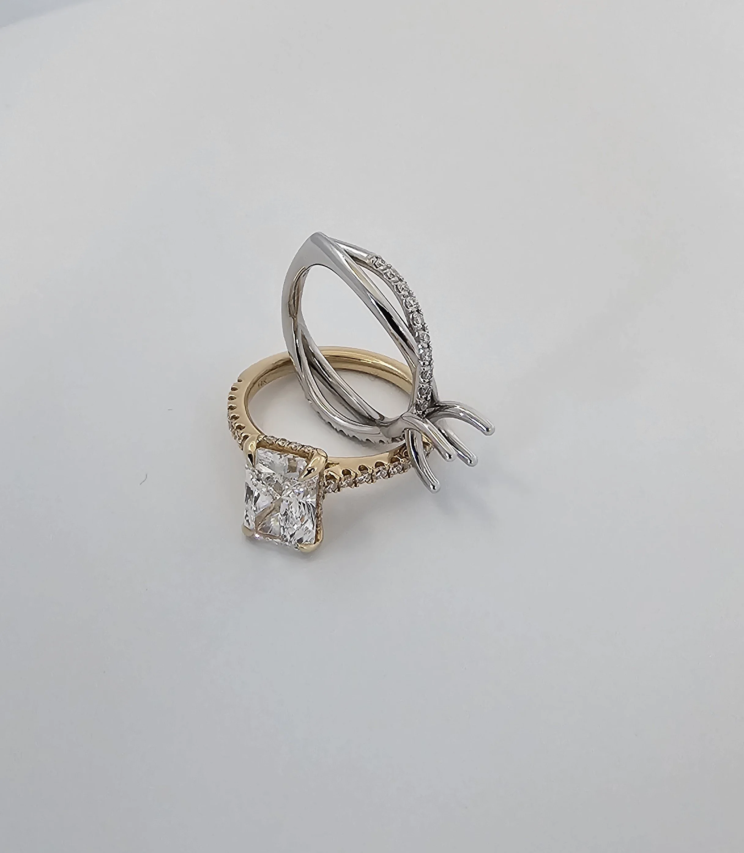 Two engagement rings 14 kt white and yellow gold with diamonds
