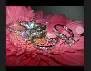 Custom designed & made 14 kt white gold engagement rings with natural diamonds. Modern and ventage designs.  jewelry is placed on the flower.