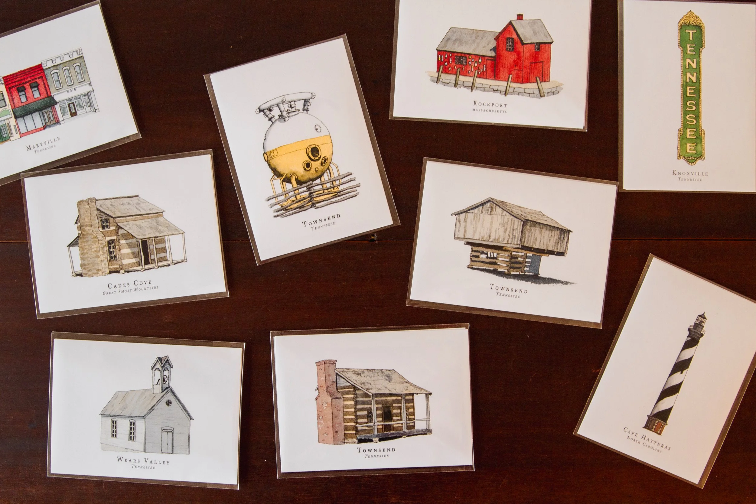 Collection of illustrated postcards featuring buildings and landmarks in Tennessee and other states, including towns, a lighthouse, a barn, and a lighthouse, with some labeled with place names like Rockport, Townsend, and Wears Valley.