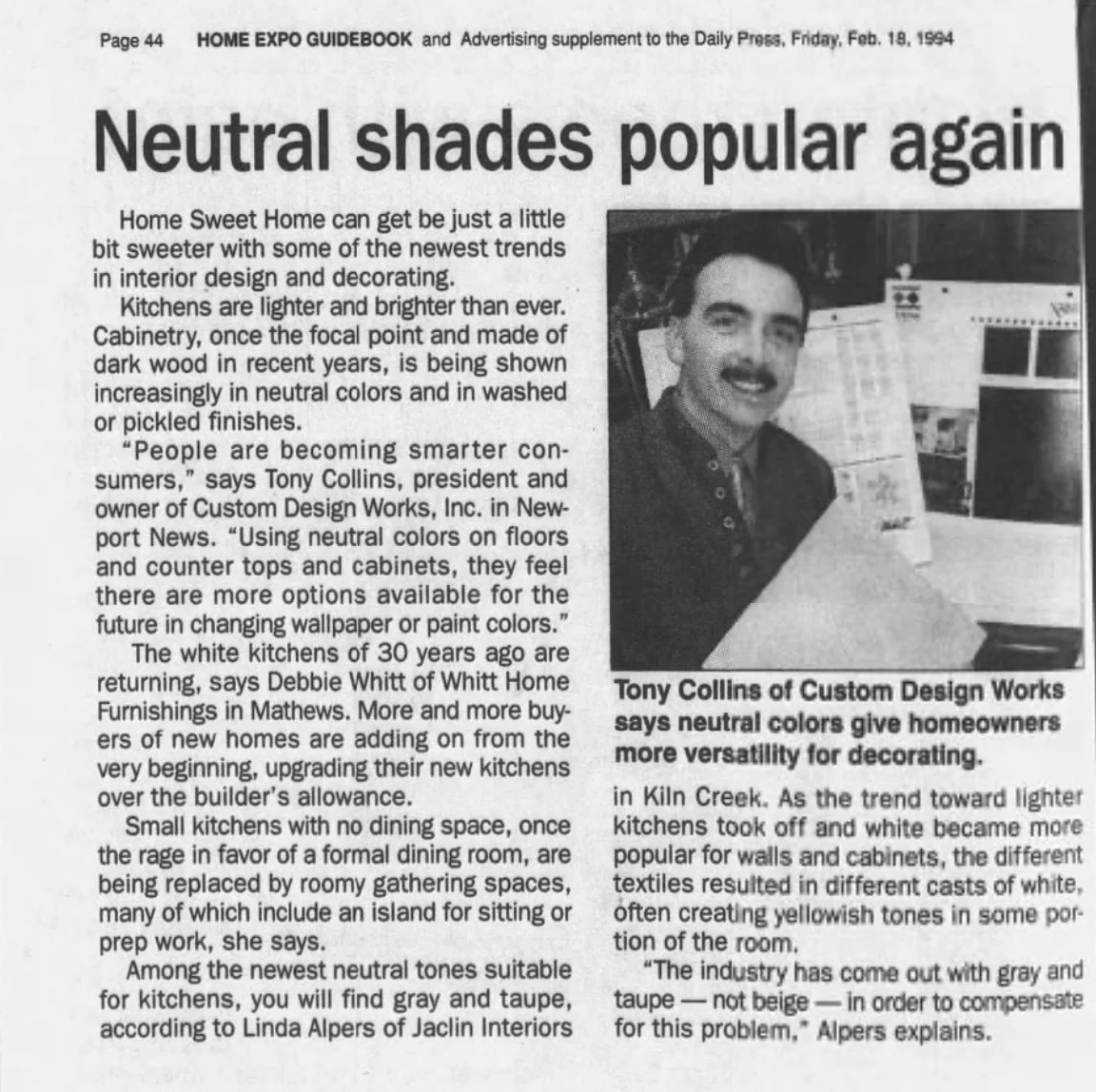 Newspaper article titled "Neutral shades popular again" with a photograph of Tony Collins of Custom Design Works, who is smiling and seated at a desk. The article discusses trends in interior design, focusing on neutral colors for kitchens and cabinets.