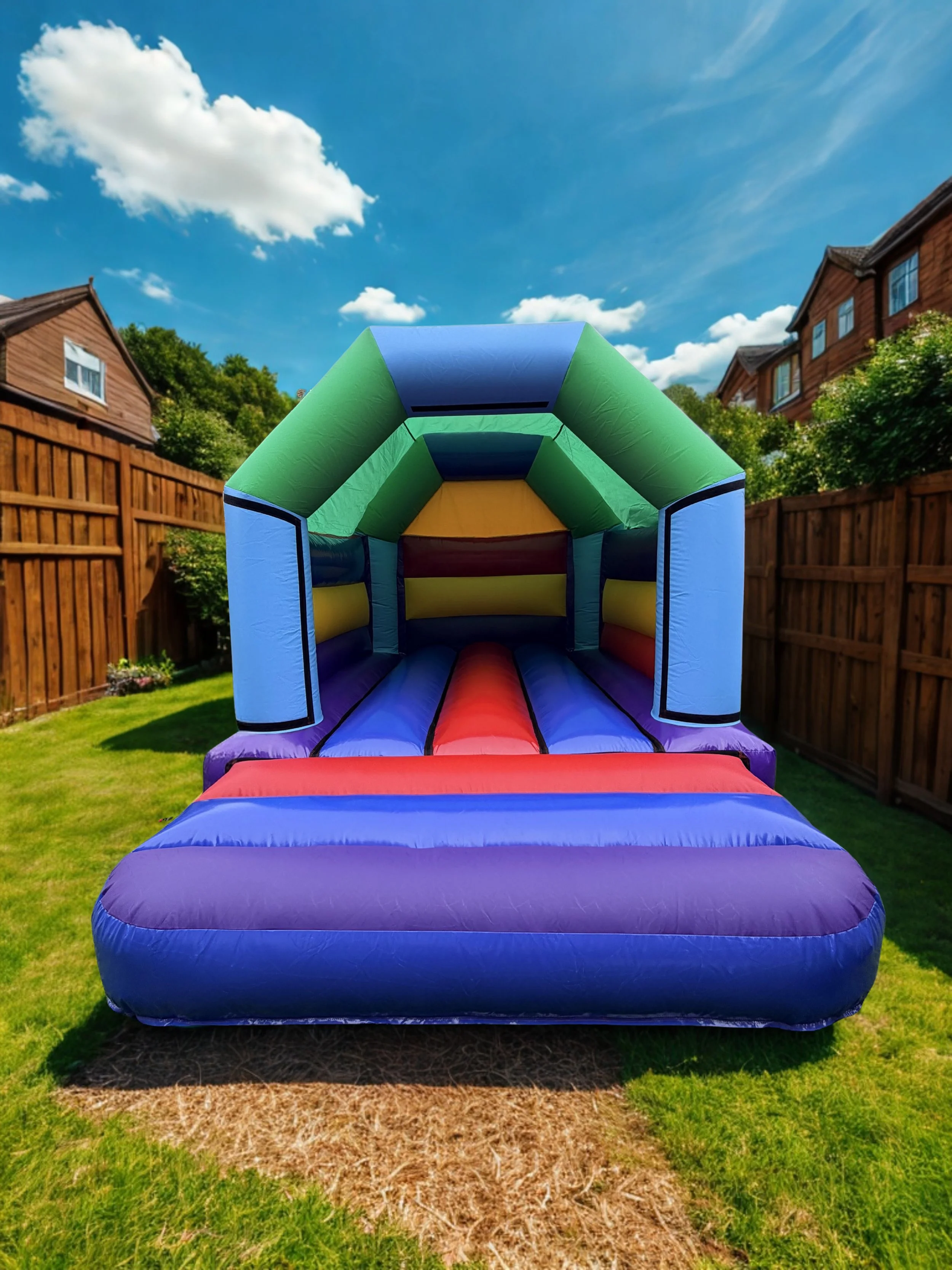 Colorful inflatable bounce house in a backyard on a sunny day.