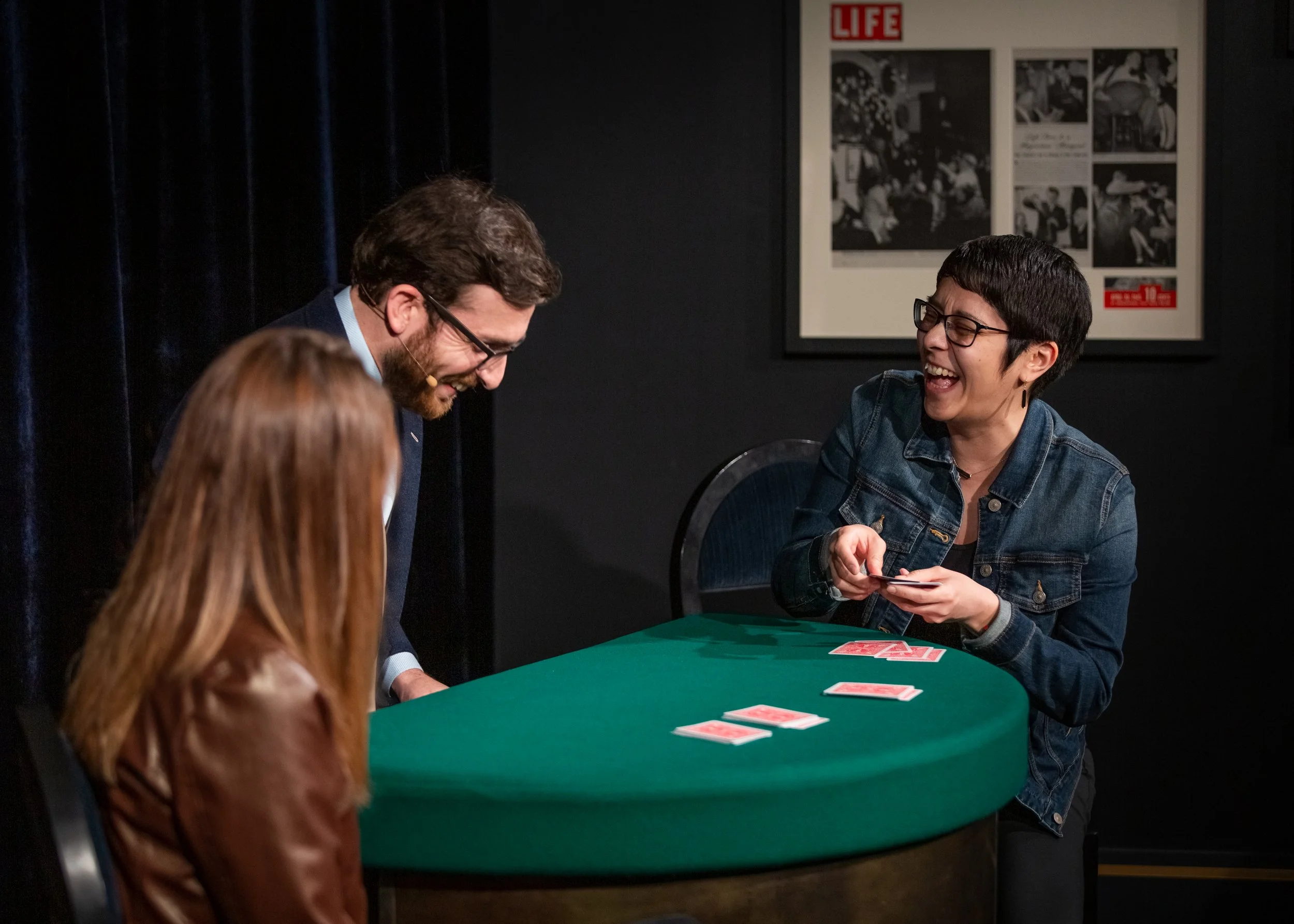 Michael Feldman performs magic for two women at a stage show - How to Choose the Right Entertainment for a San Francisco Event