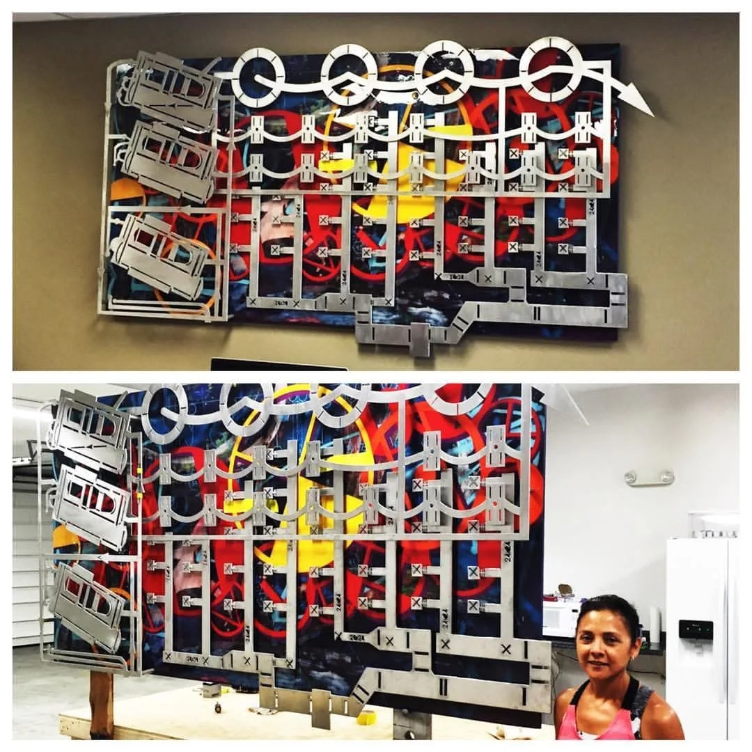 An artistic installation with a colorful abstract background and various metal or plastic components attached, resembling a game or puzzle, viewed from different angles; one image includes a woman beside the artwork.
