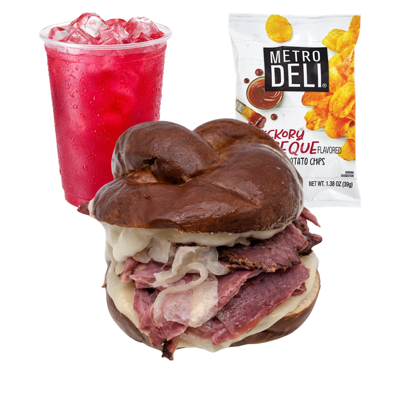A pastrami and roast beef sandwich on a pretzel bun, with a side of potato chips and a red beverage with ice cubes.