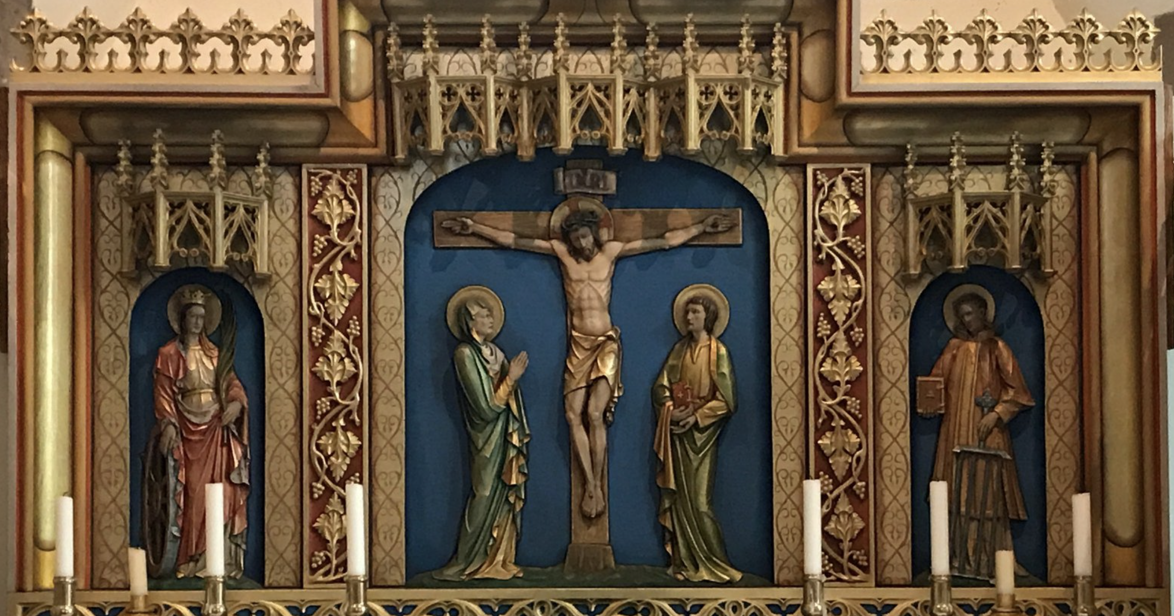 Iconography of the Crucifixion carved in relief on the reredos of a Western altar.