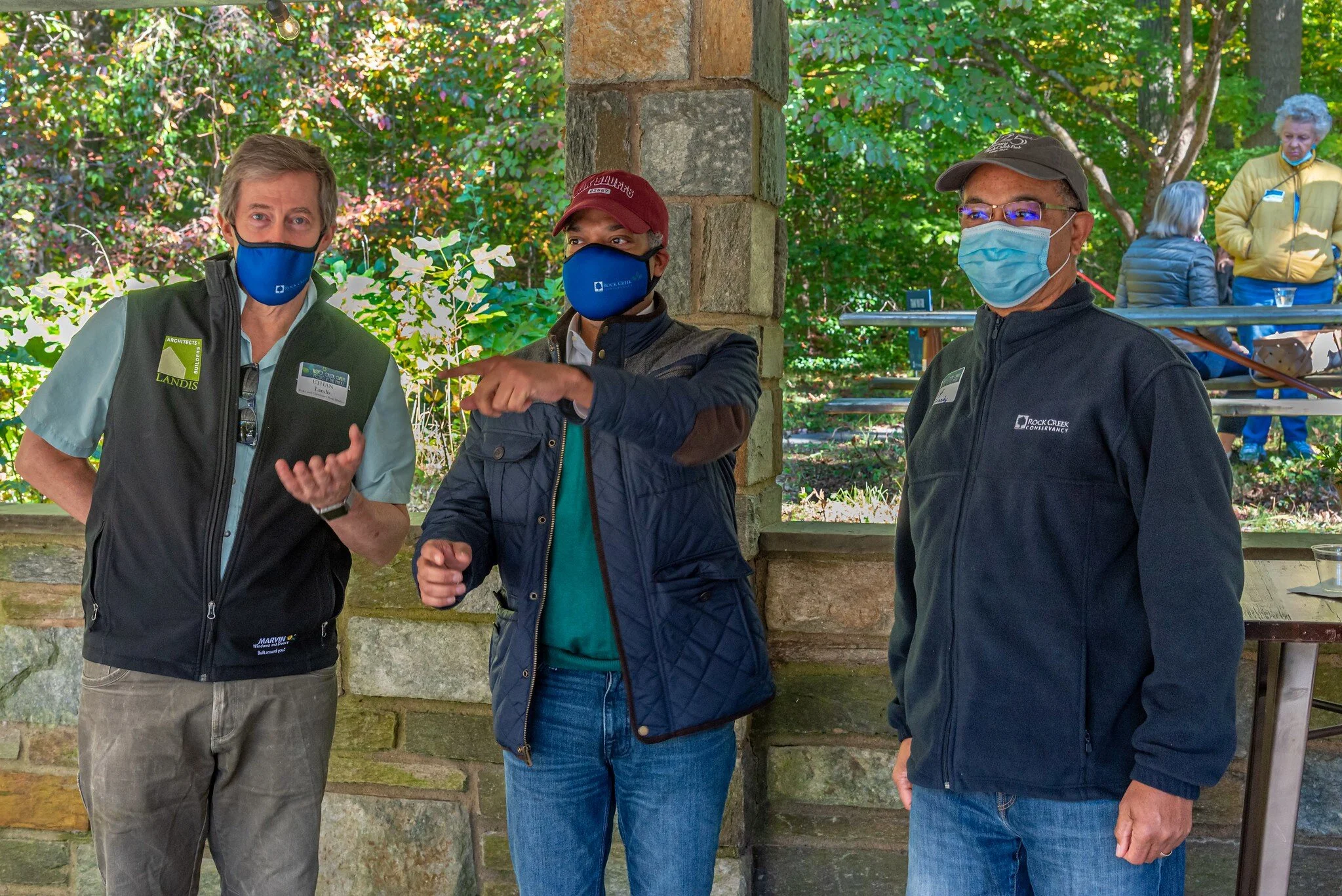 Councilmember Brandon Todd (center) chats with Rock Creek Conservancy Board member Ethan Landis (left) and H. Clifton Grandy (right) at the Carter Barron Amphitheater.