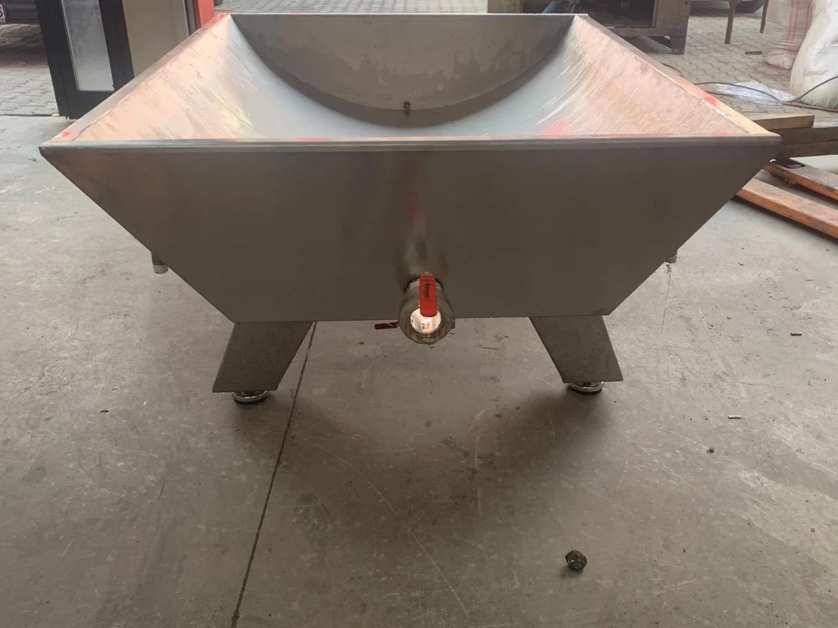 Stainless steel industrial machine with a rounded compartment on top and a valve with a red handle at the front.