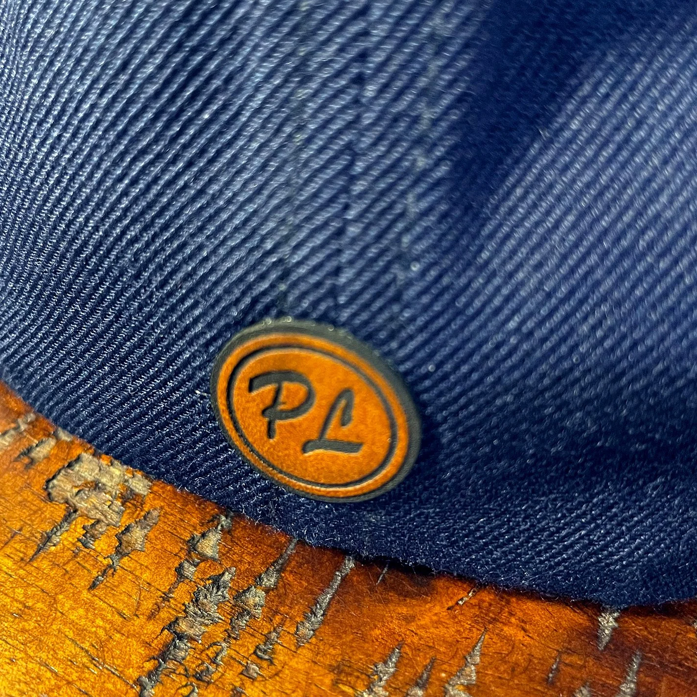 small leather patch with initials