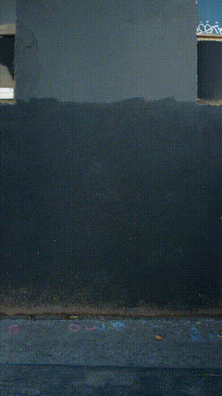 A close-up of a dark-colored rug or carpet on a floor.