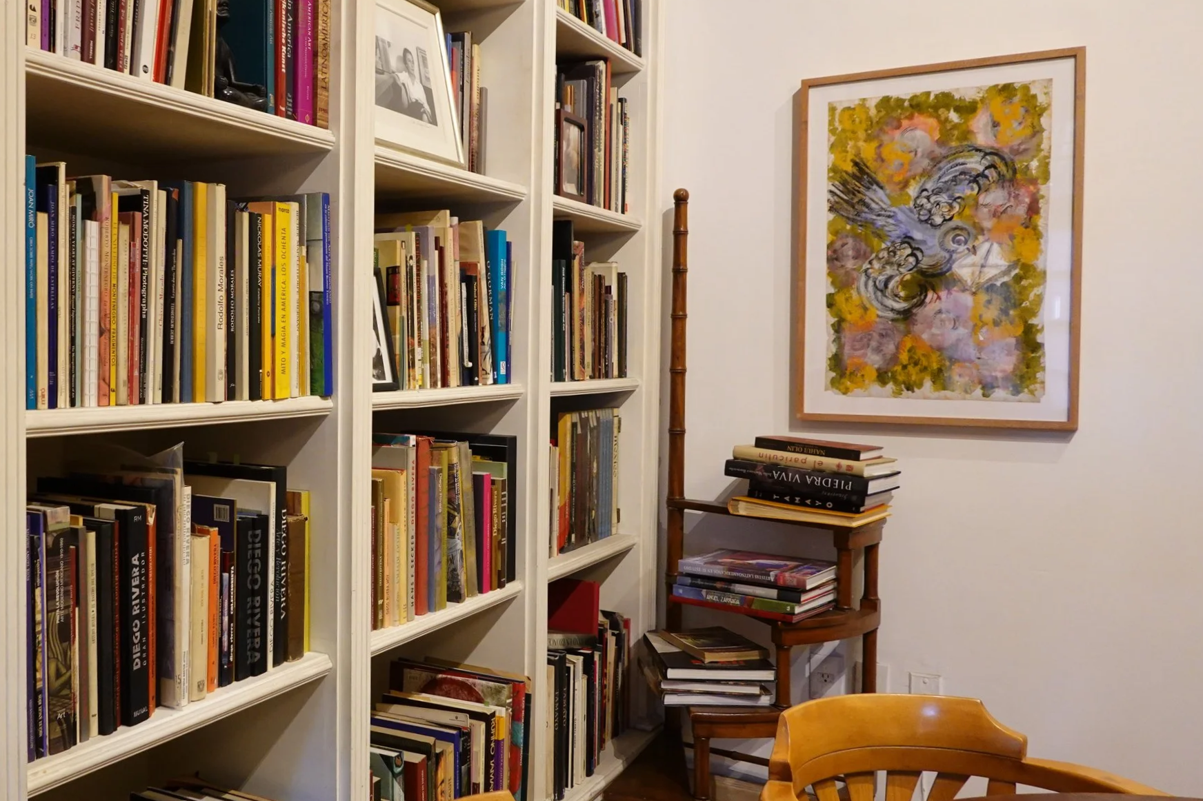 Biblioteca con obra gráfica enmarcada