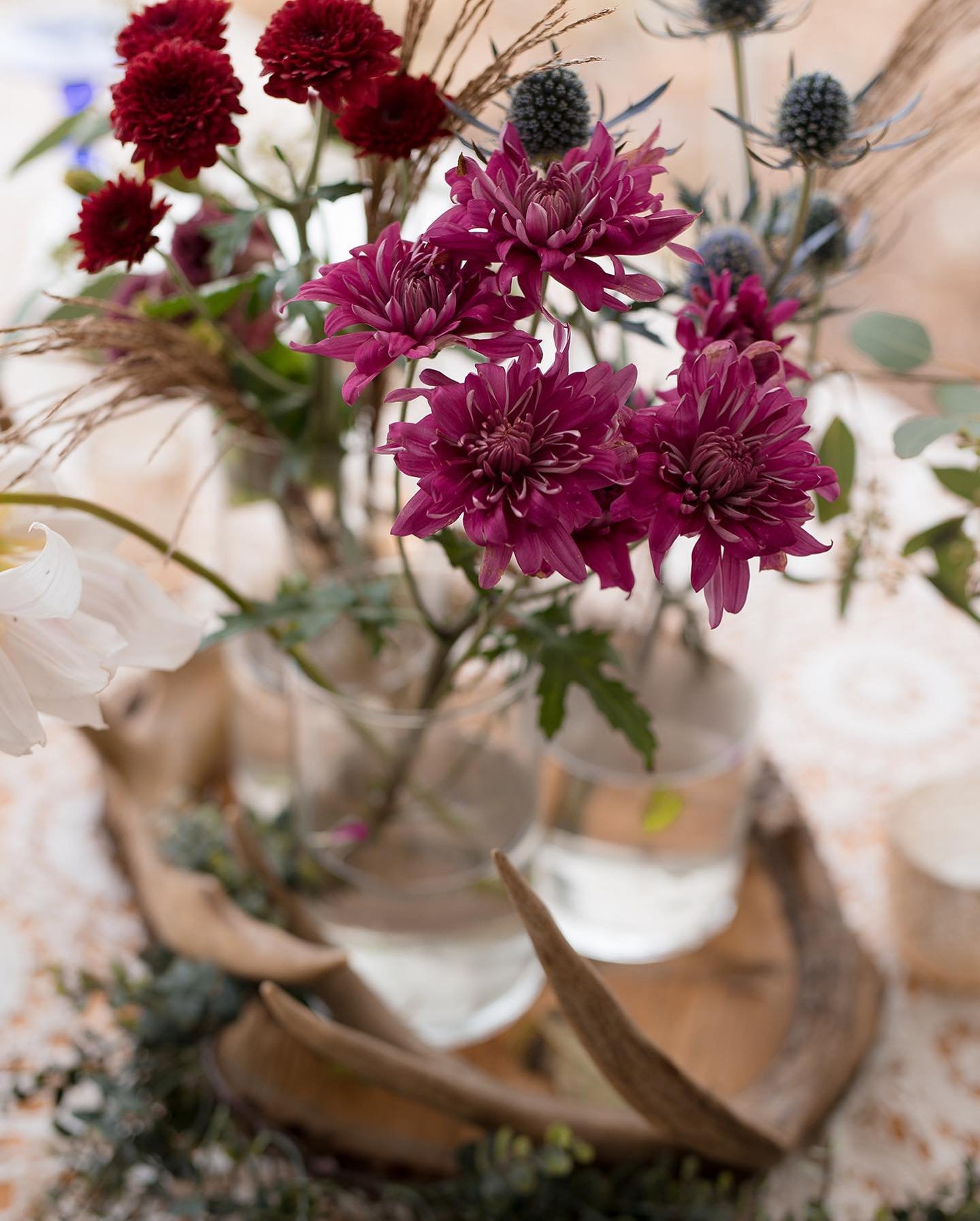 A bouquet of various colorful flowers in a glass container.