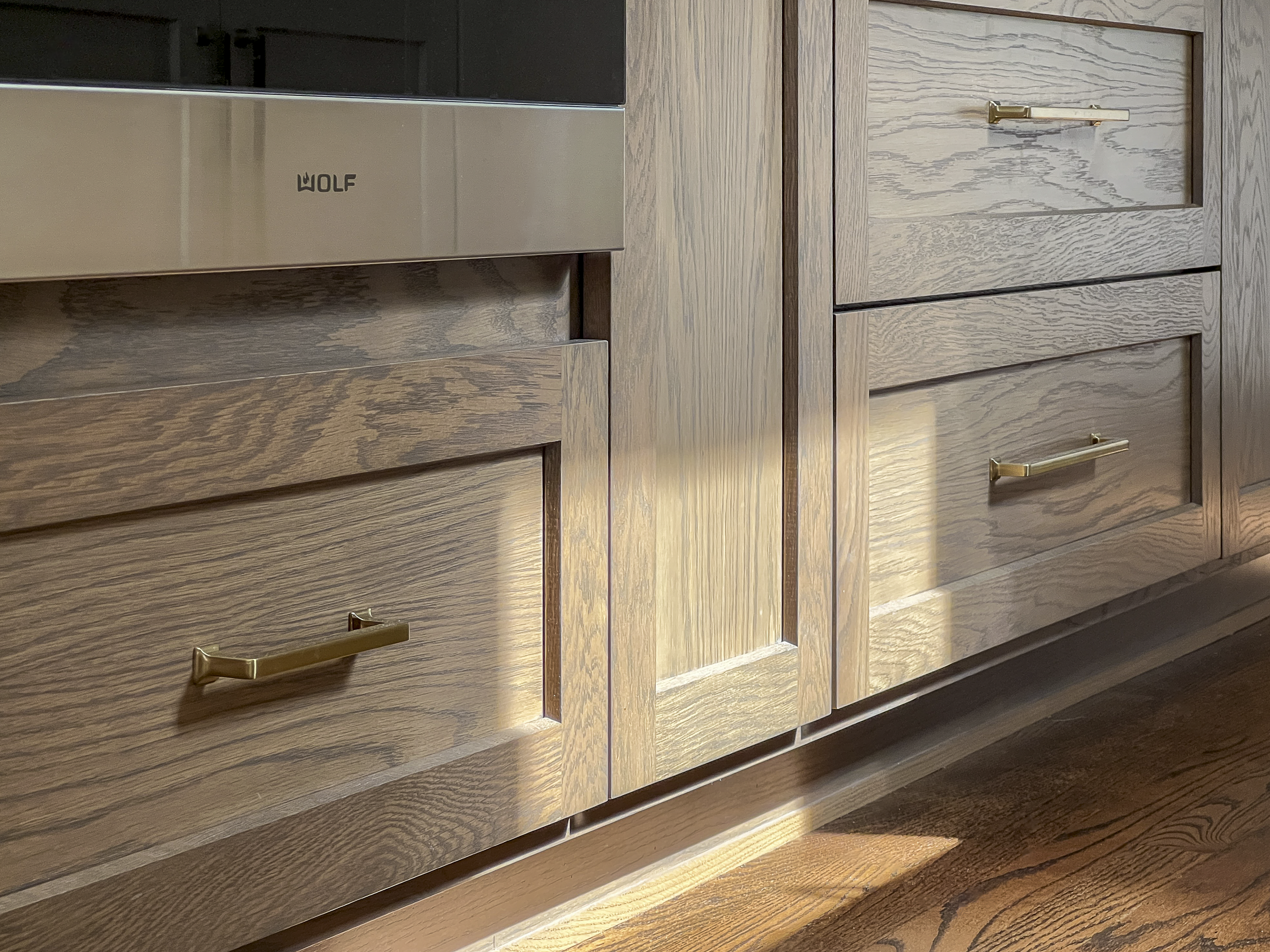 Close-up of wooden cabinets with metal handles.