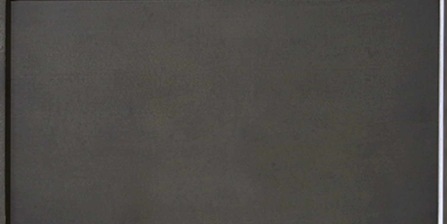 Close-up of a computer monitor with a blank, dark screen.