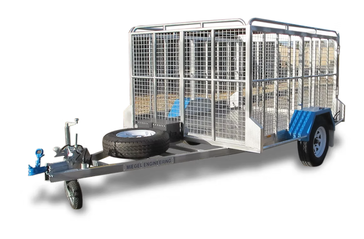 A cage trailer with a metal cage structure, a spare tire, and a hitch, branded with 'MIEGEL ENGINEERING' on the side