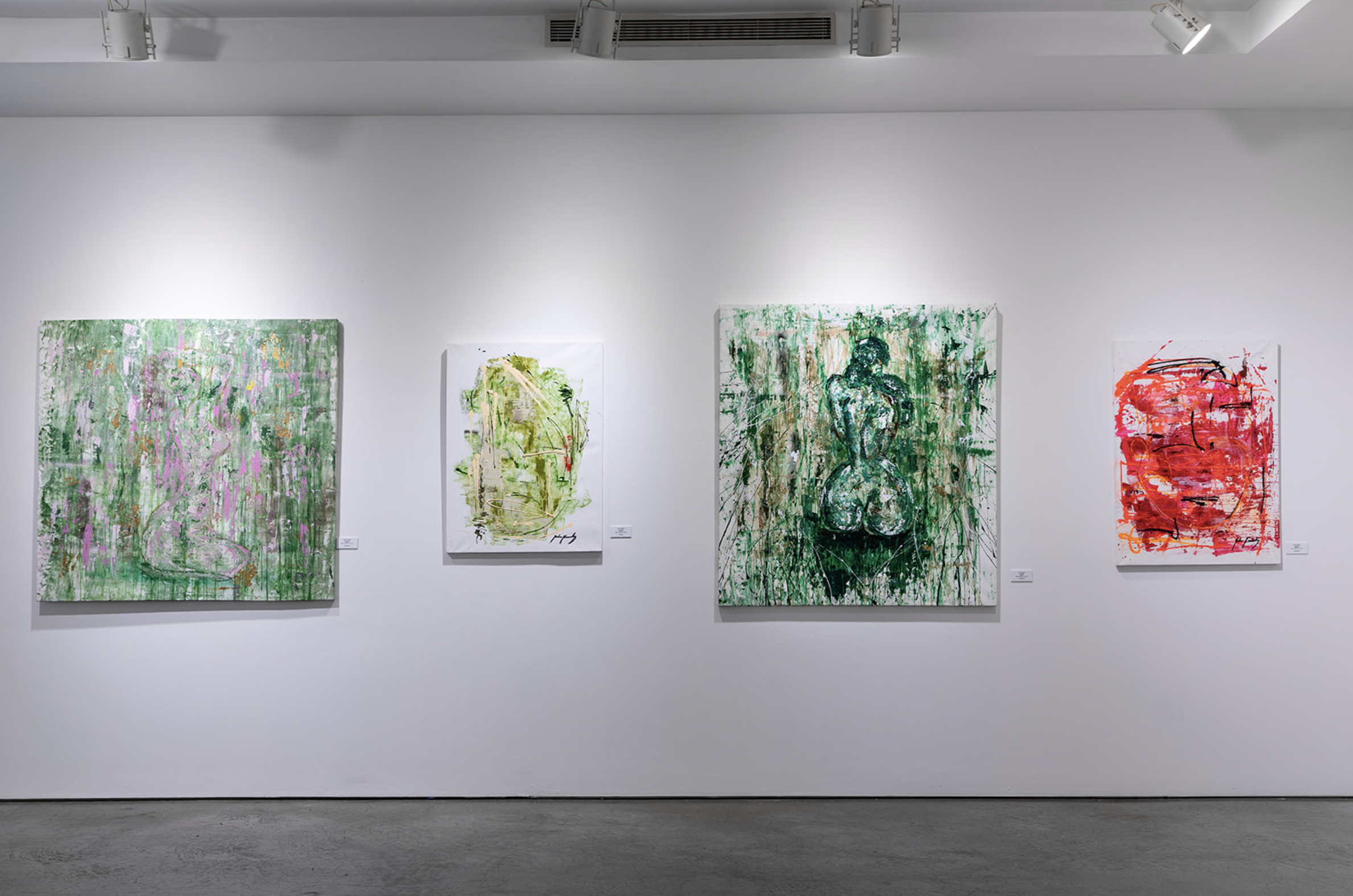 Four abstract expressionist paintings on a white gallery wall, featuring gestural brushstrokes and figures in predominantly green, pink, and red hues.