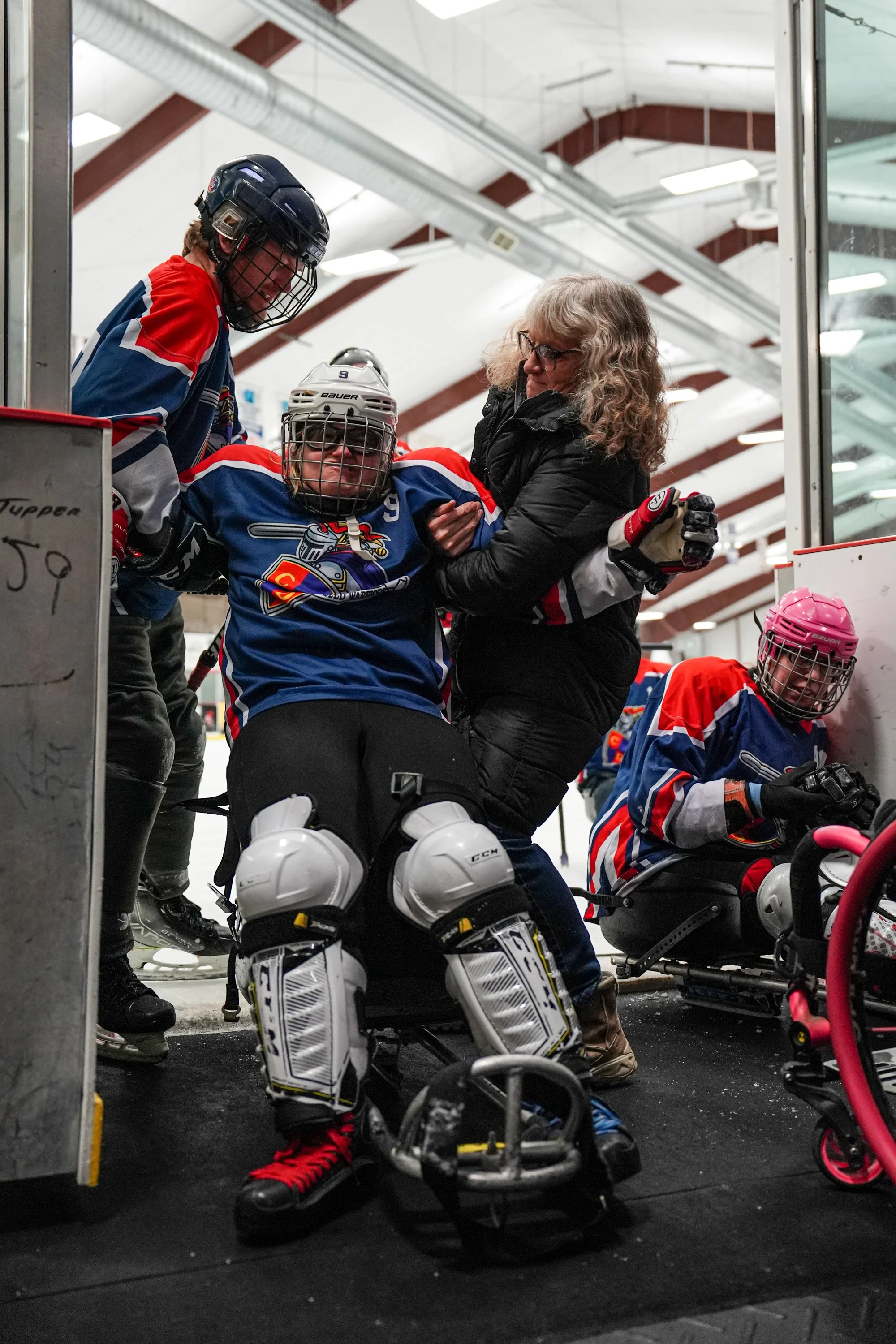 Capital District Sled Warriors player Abigail Radliff is helped up from her sled during her game vs CNY Flyers on February 6, 2026 at the Tupper Lake Civic Center in Tupper Lake, NY. (Isaac Williams/The Newhouse School)