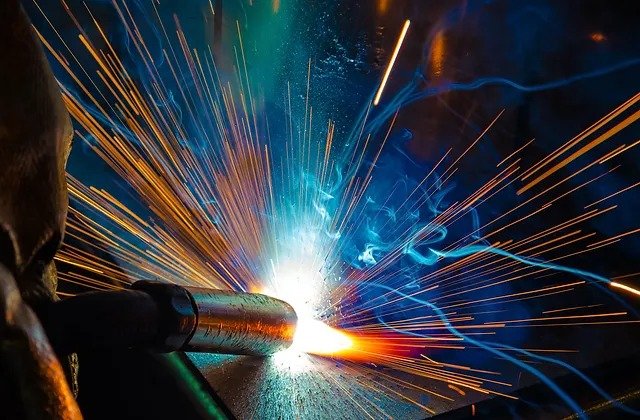 Welding process with sparks and bright light from welding torch