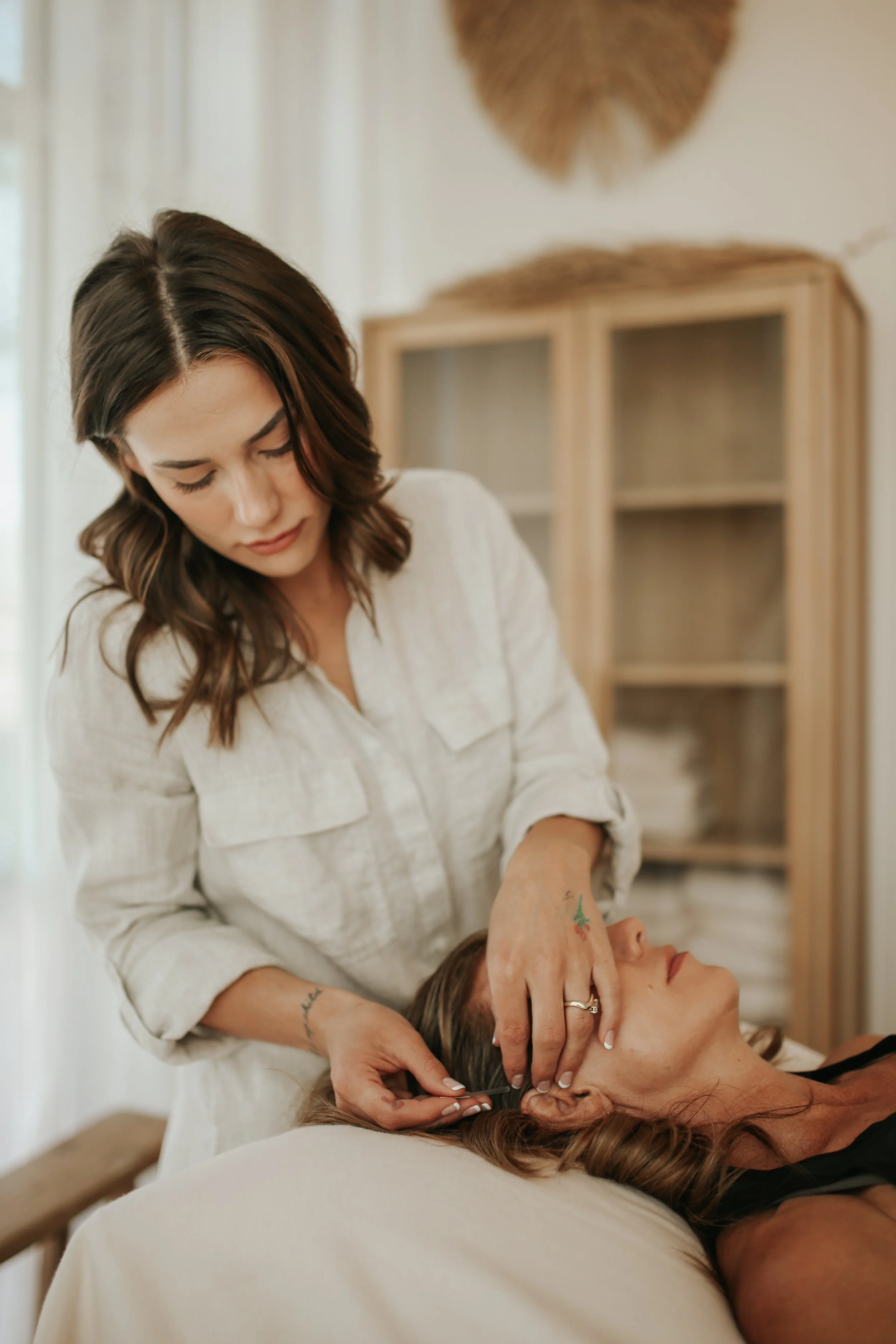 Acupuncturist placing a needle during treatment.