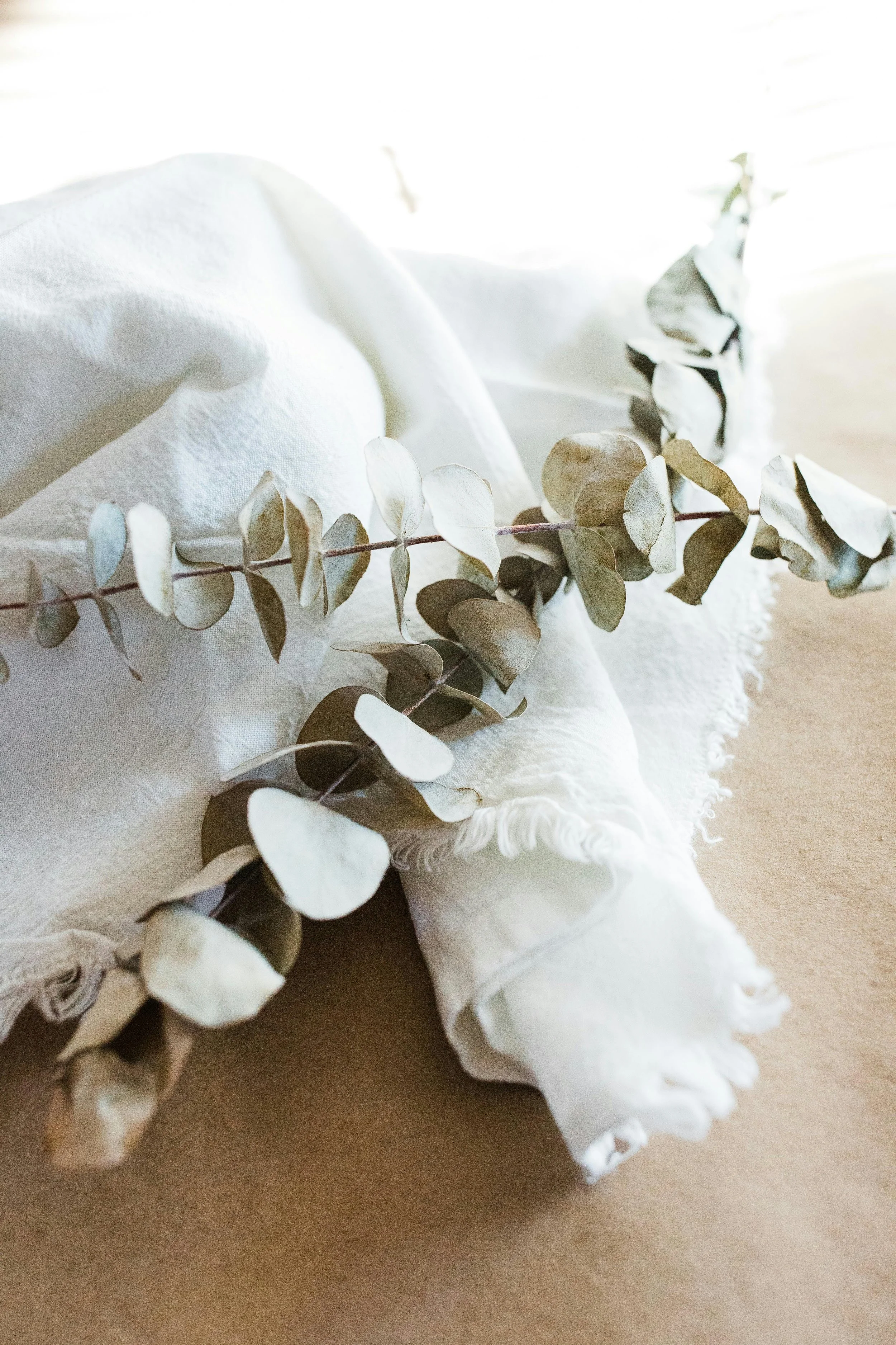 Calming eucalyptus and soft linen styling, reflecting Om Baby's gentle approach to newborn care in Los Angeles