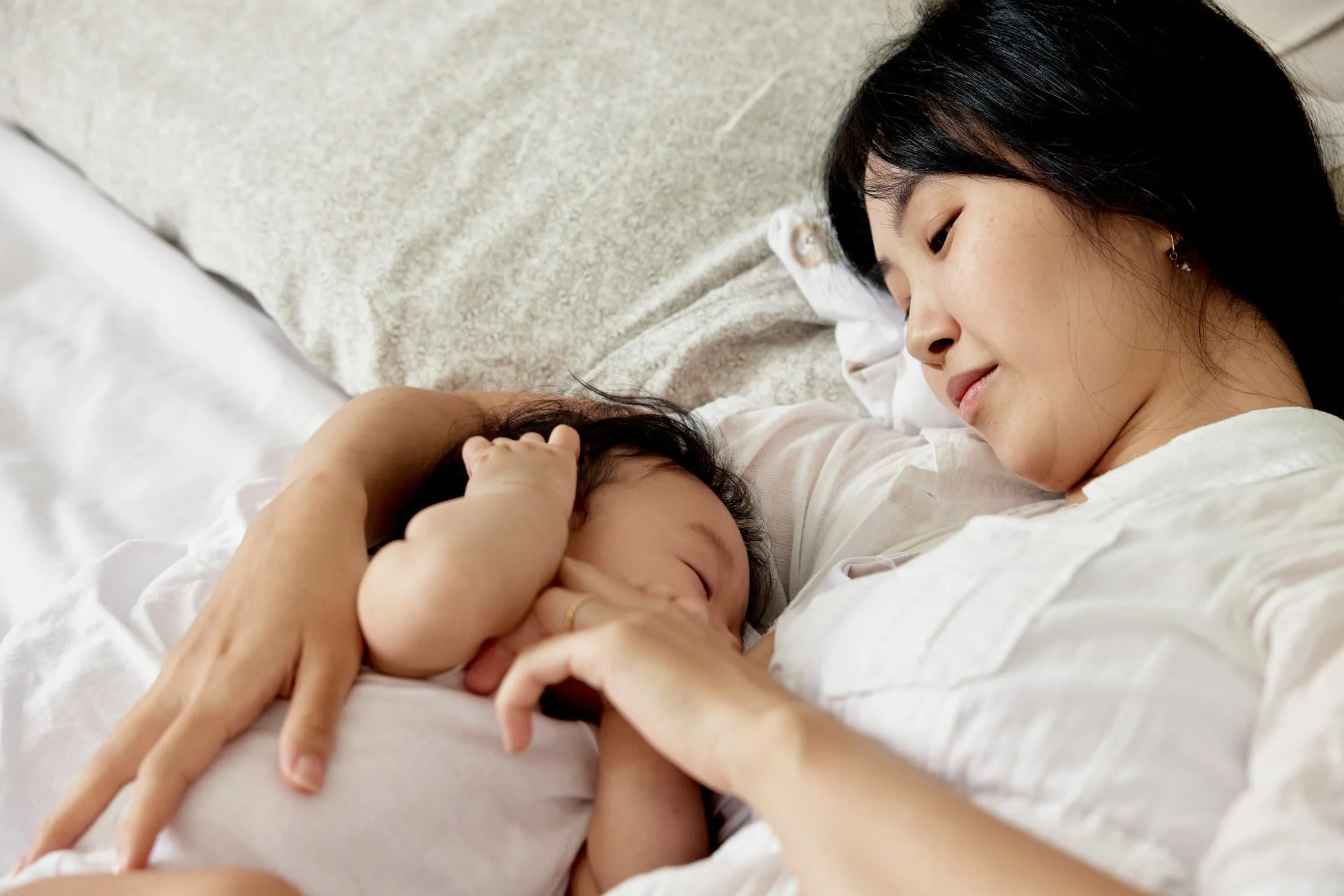Newborn lying peacefully on safe sleep surface, reflecting Om Baby's gentle newborn sleep coaching in Los Angeles